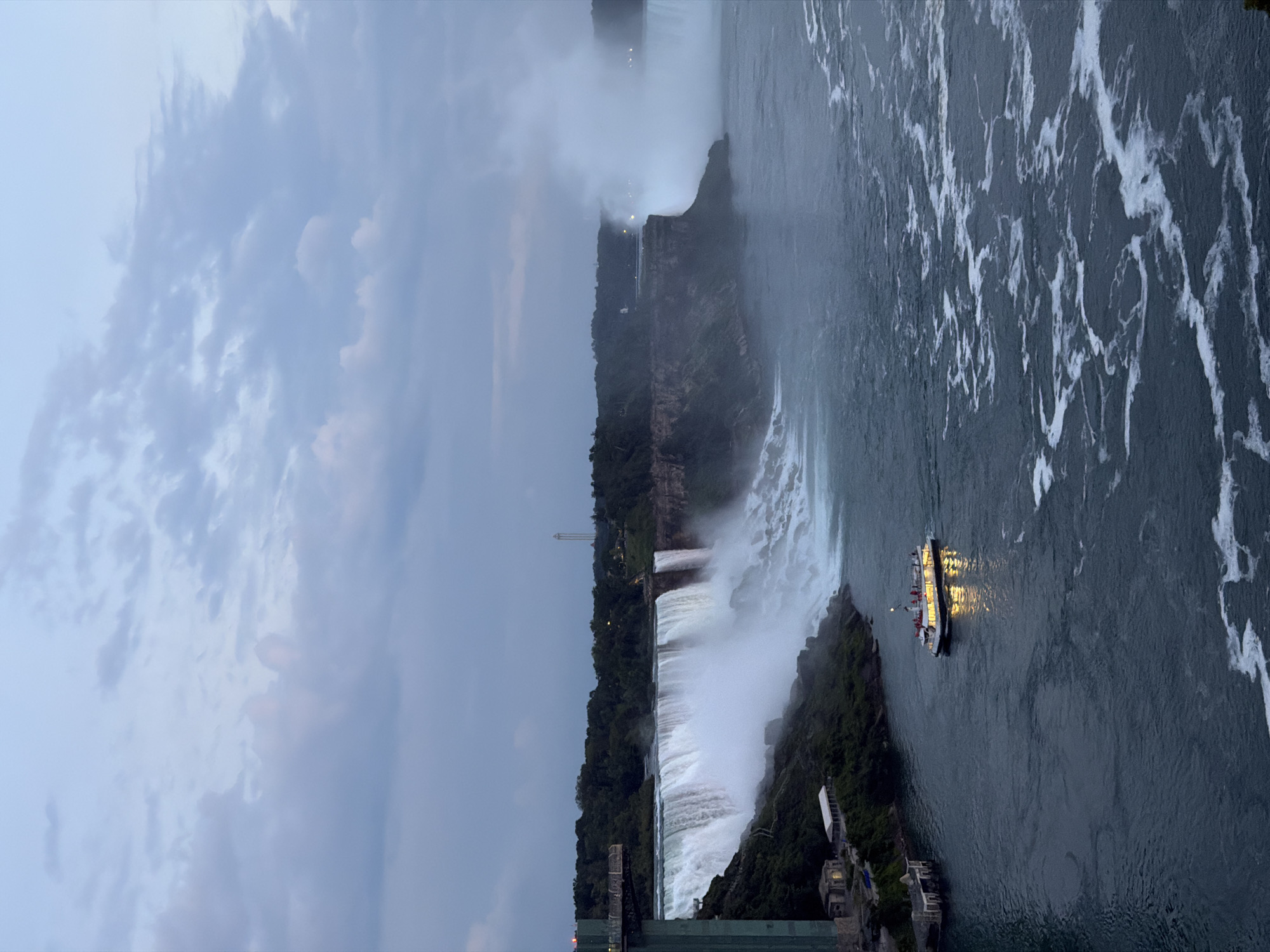 Horseshoe Falls at dusk, lit tour boat in the mist