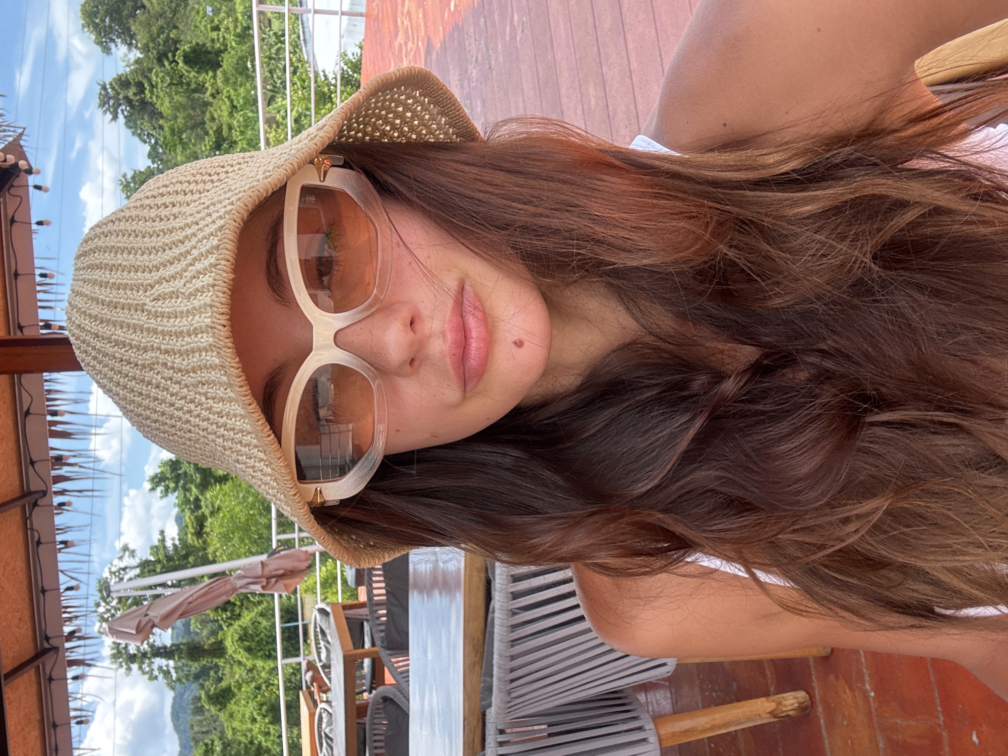 Woman photographed at outdoor restaurant in Kathu, Thailand
