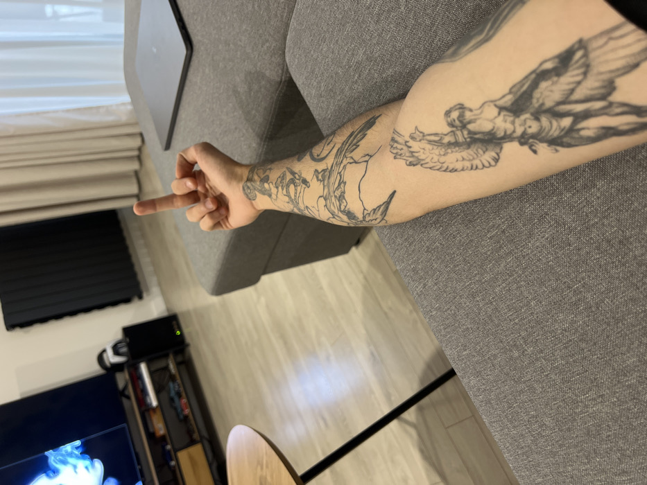 Morning moments: tattooed man and foggy Tbilisi cityscape