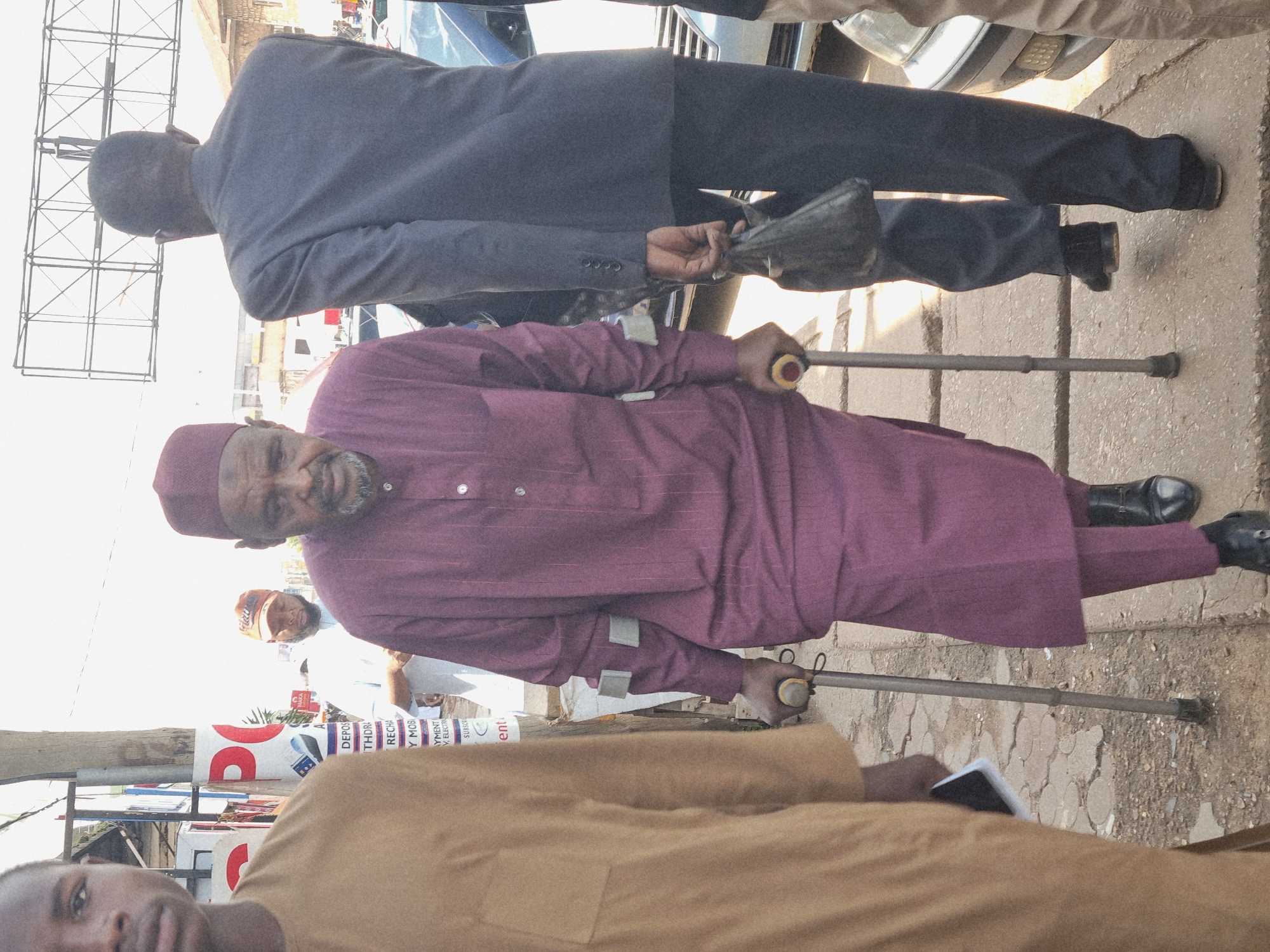 Midday street life and vendors along a Jos, Nigeria corridor