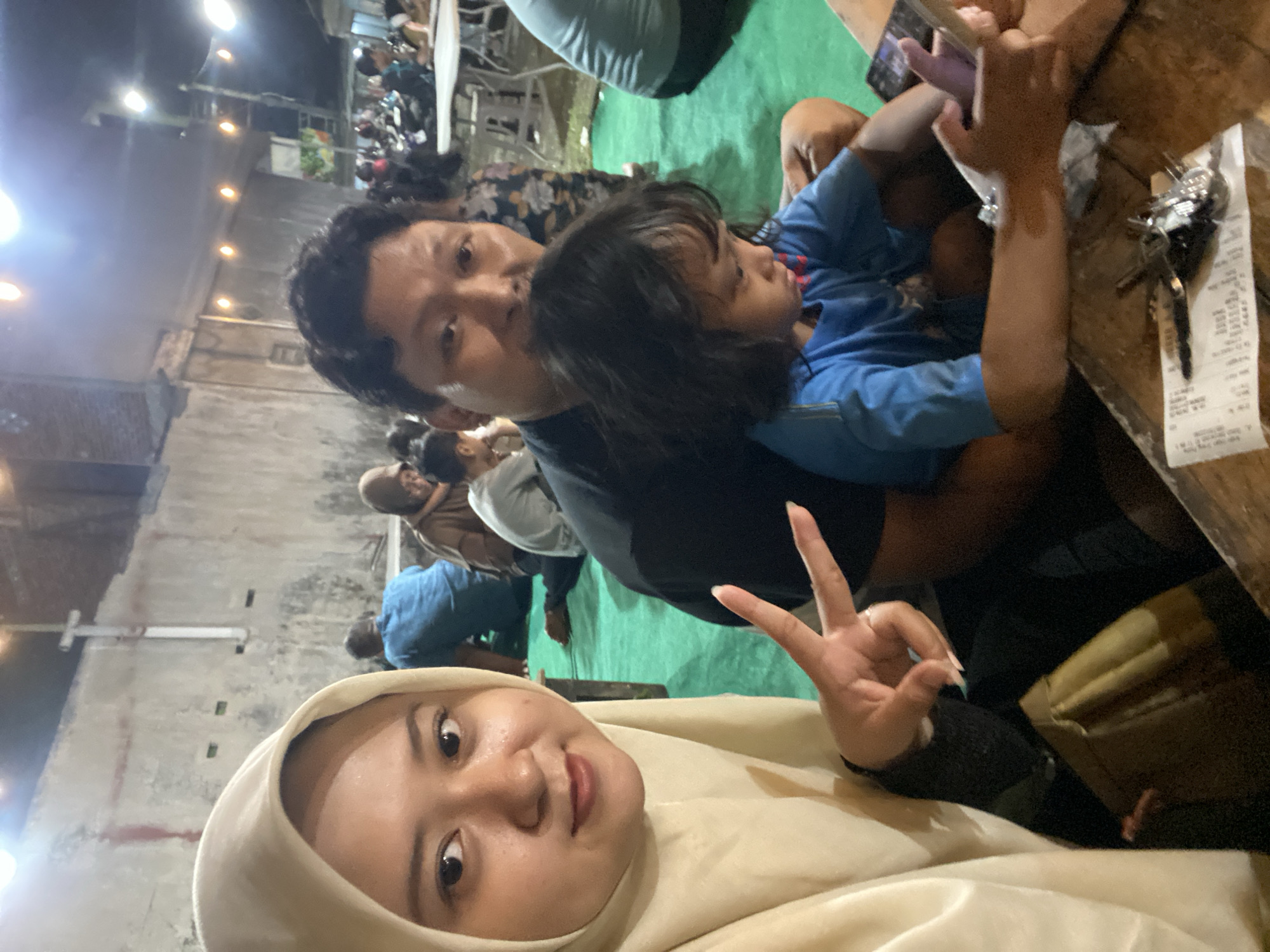 Family enjoys outdoor meal together in Sidoarjo, Indonesia