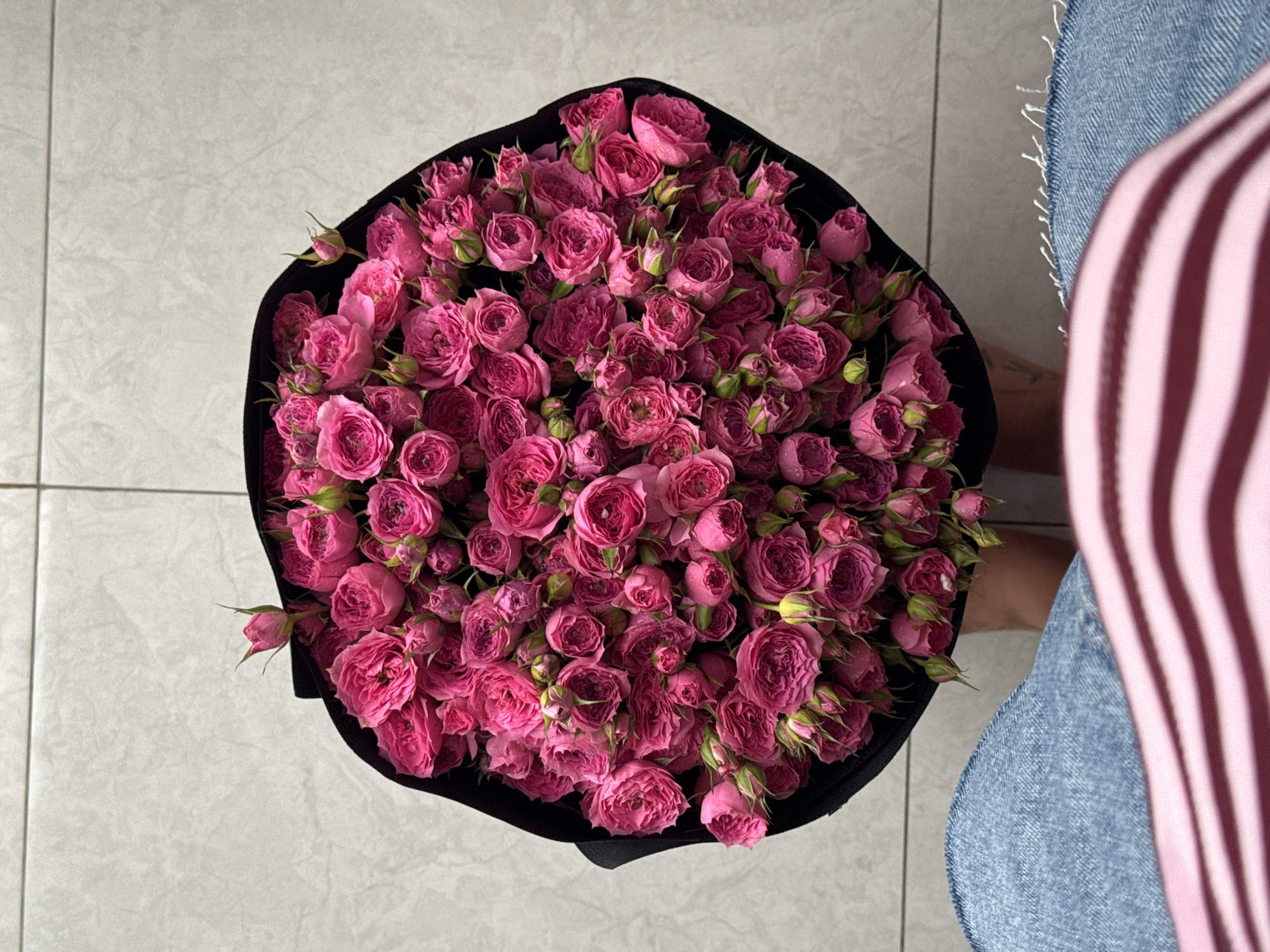 Pink rose bouquet in black wrap, overhead view, Nha Trang