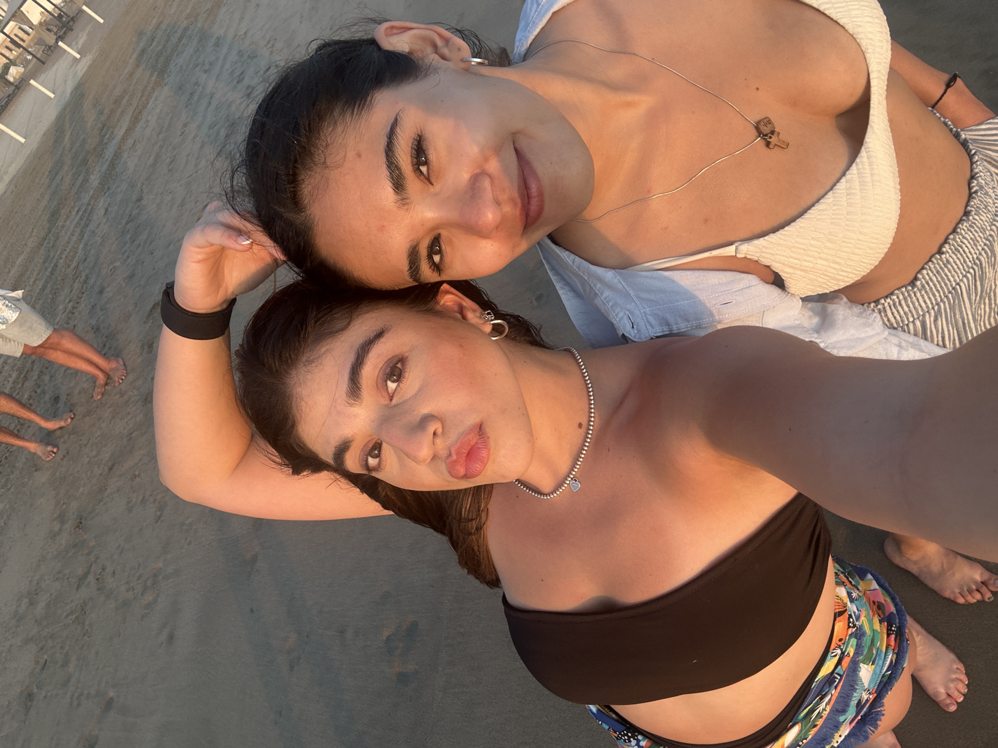Women take beach selfie during Acapulco sunset gathering