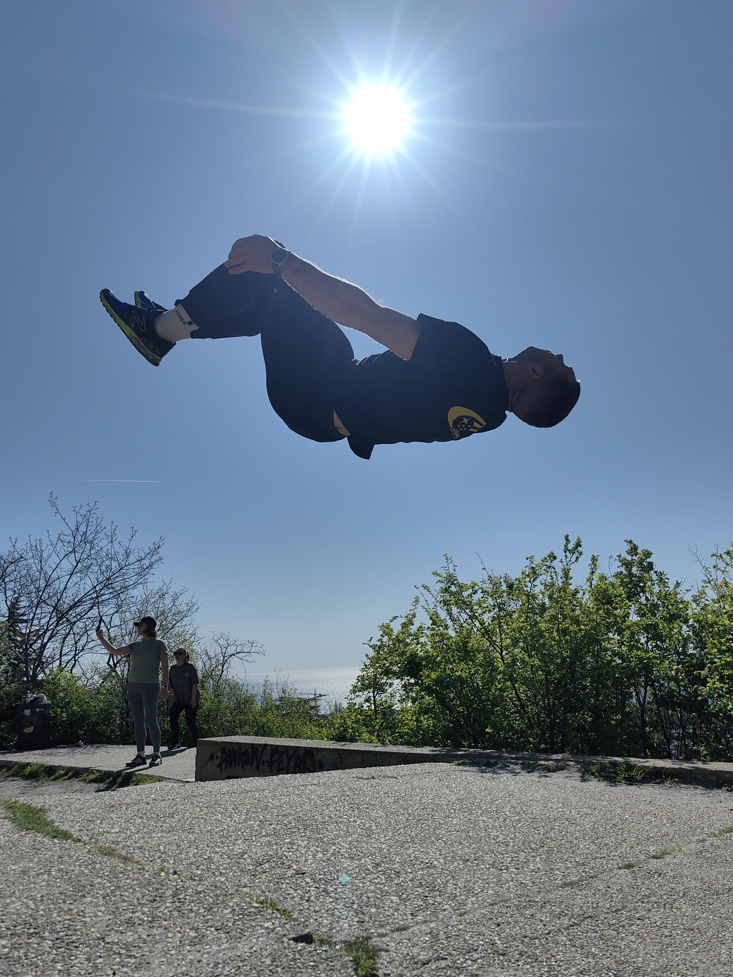 Man performs backflips and aerial stunts in urban park
