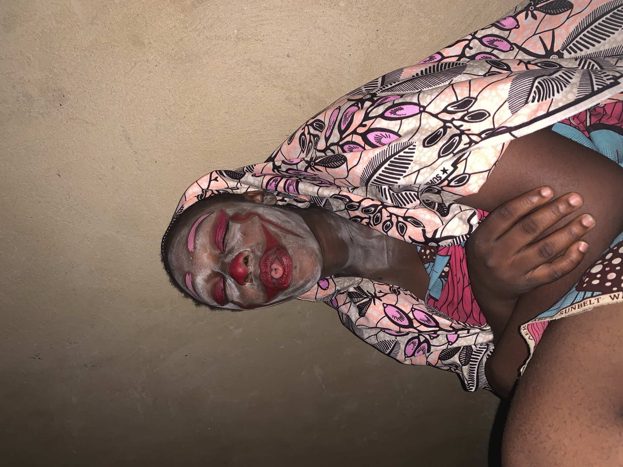 Clown performer documented in multiple poses in Agban, Nigeria