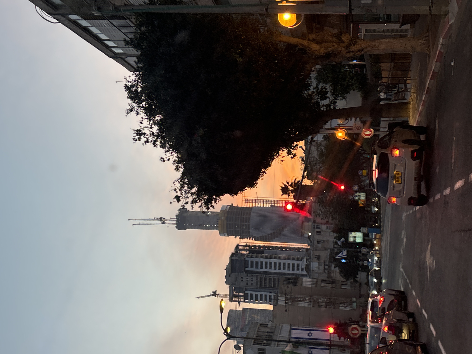 Construction cranes dominate Givatayim skyline at dusk