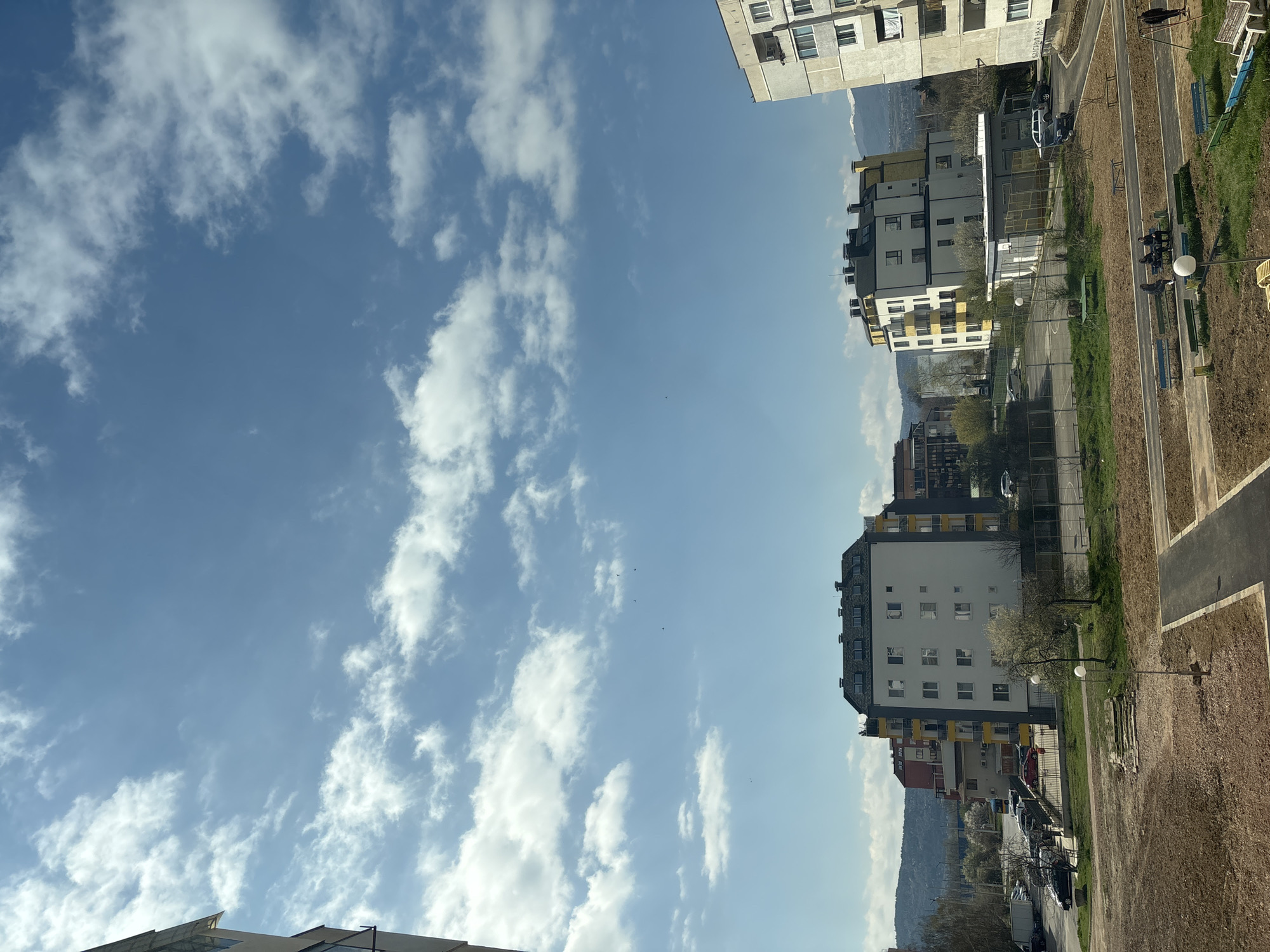 Sofia cityscape observed under bright partly cloudy morning sky
