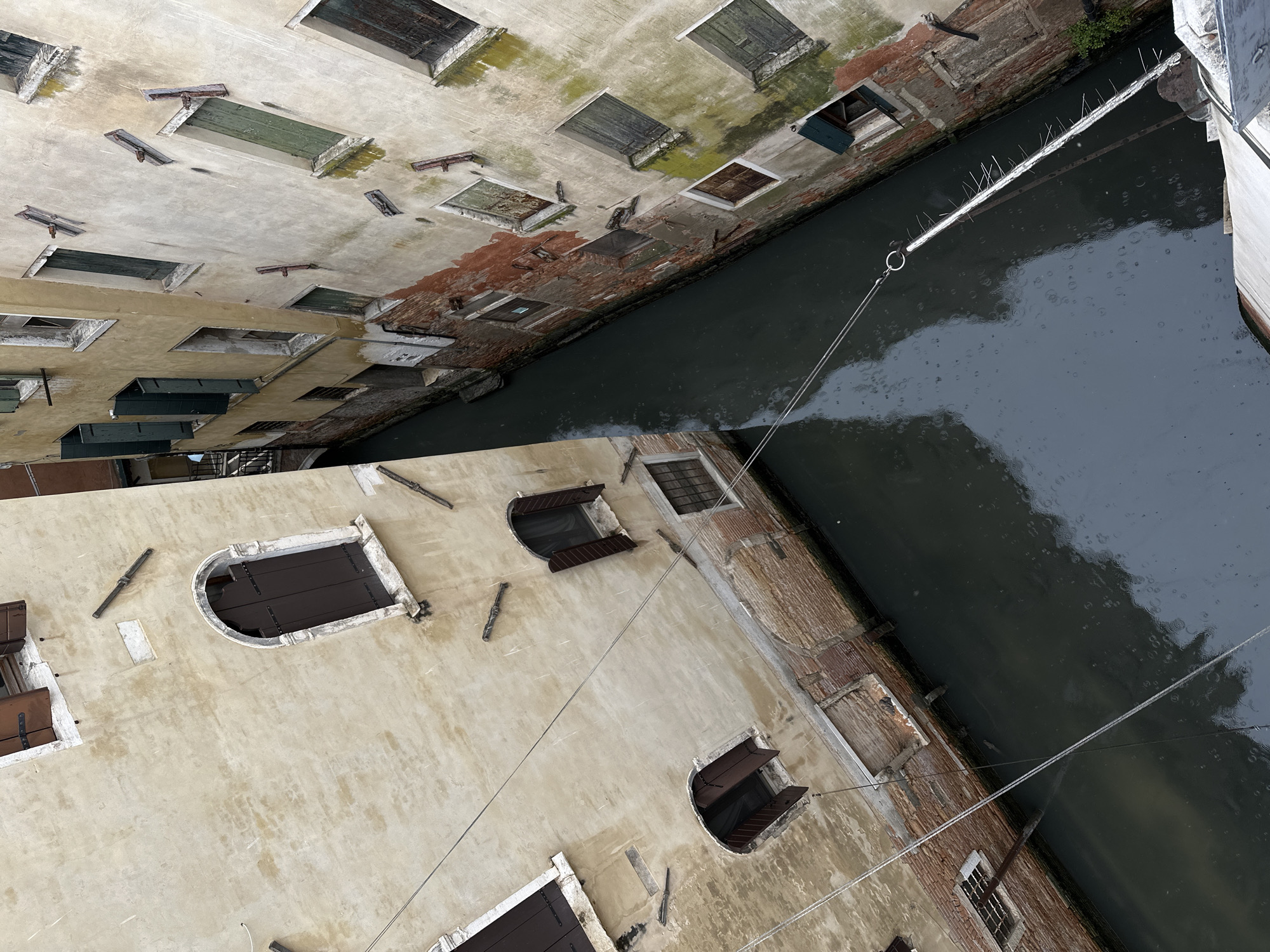 Venice canal scene documented amid weathered historic buildings