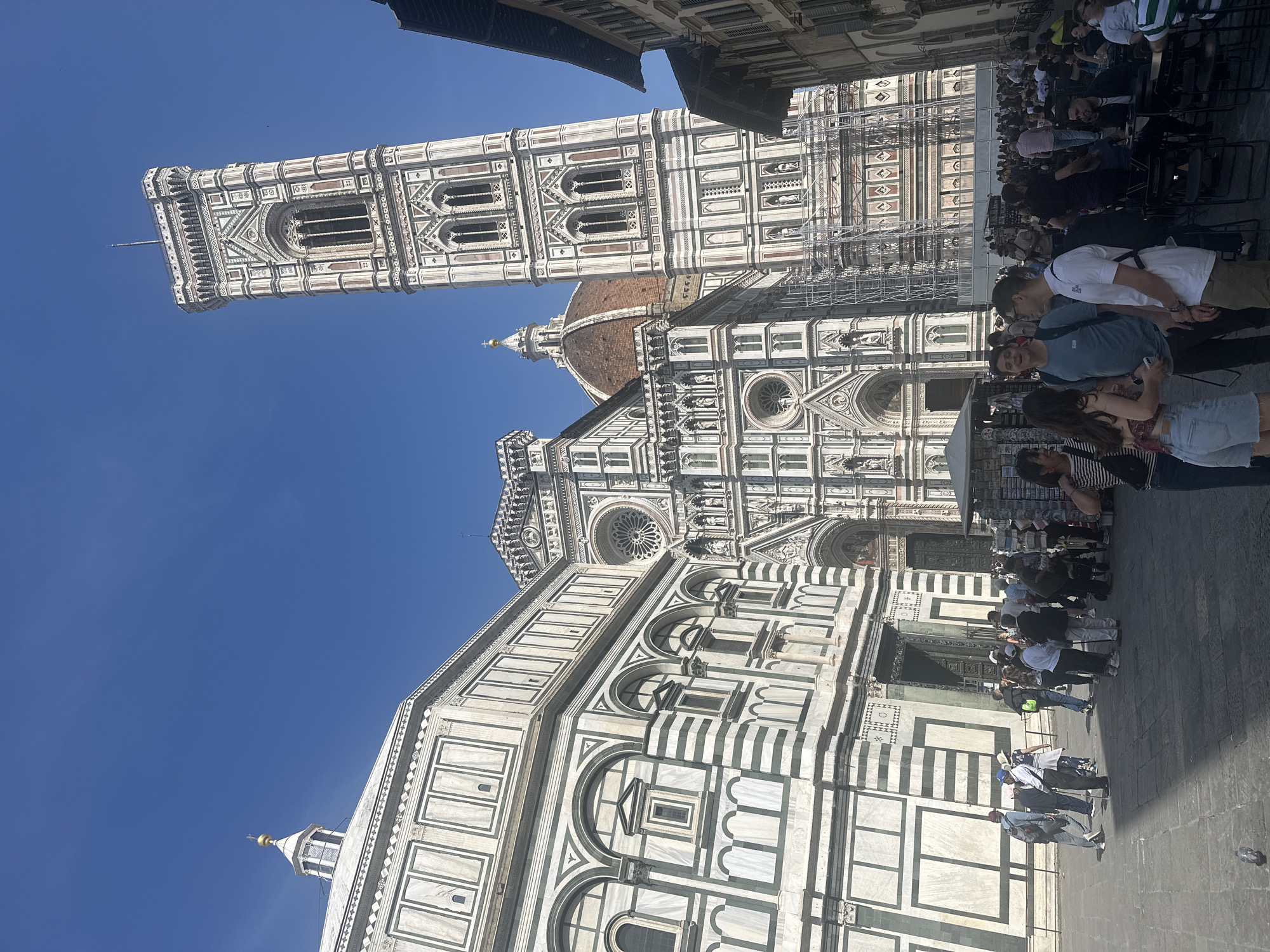 Tourist visits Florence's Duomo complex on sunny Friday afternoon