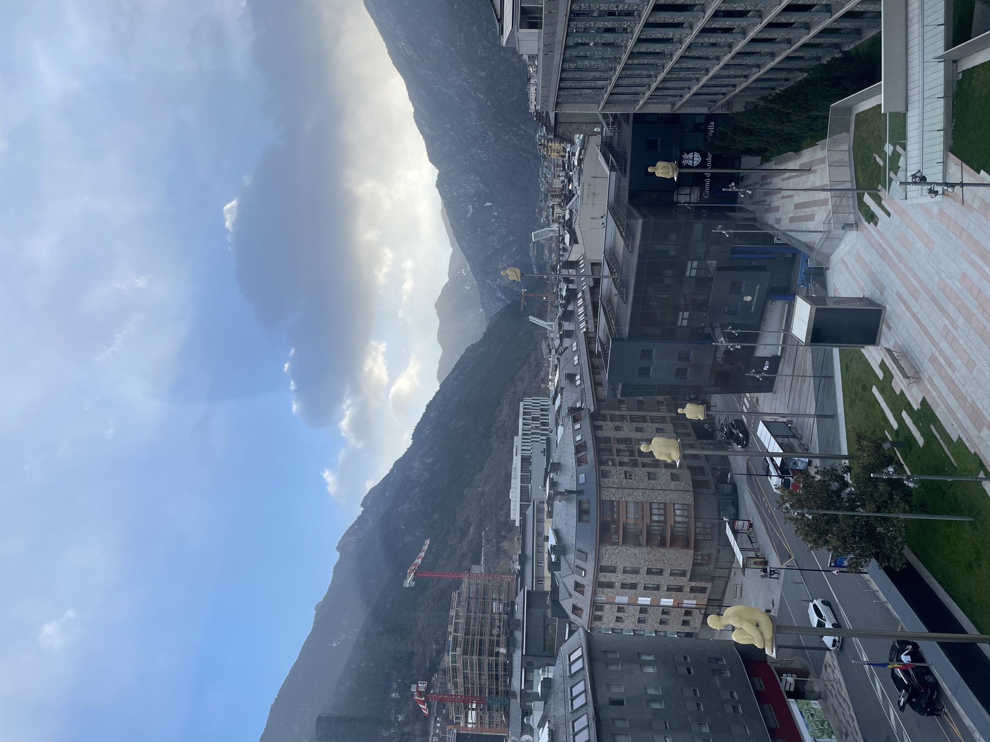 Tourist captures Andorra la Vella cityscape and street art