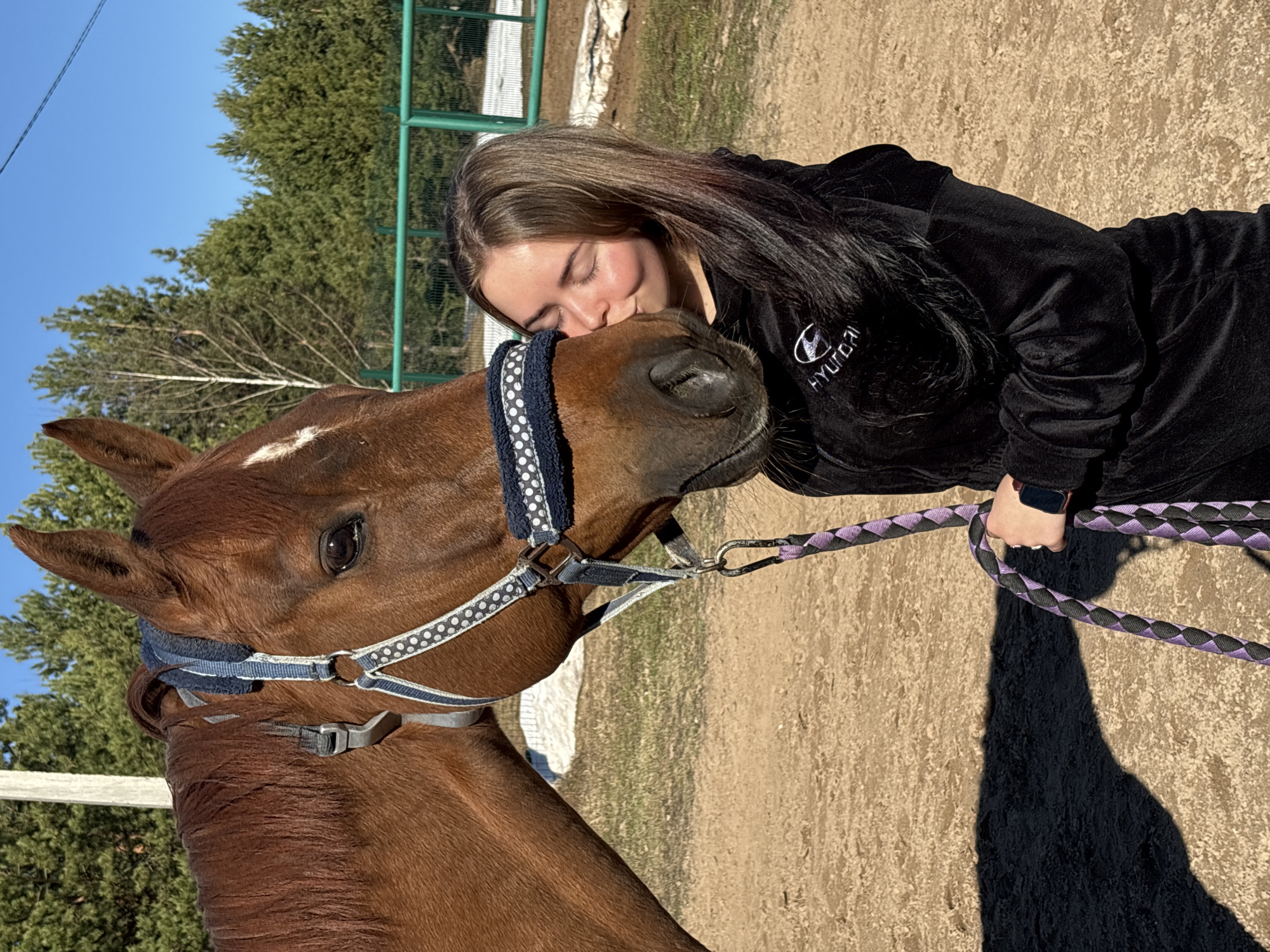 Woman shares quiet moment with horse in rural Russia