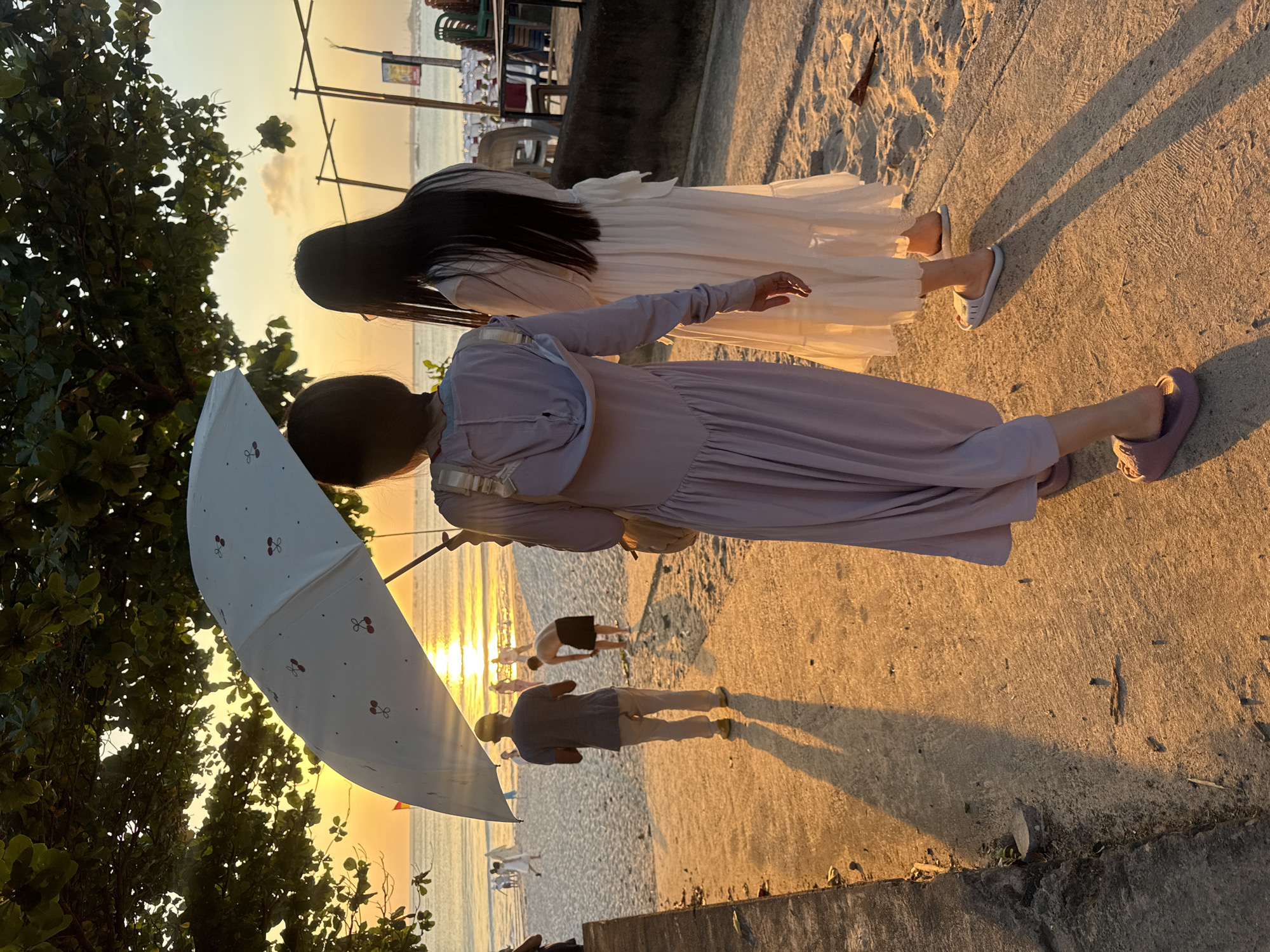 Kuta Beach at golden hour, planes landing and crowds watching the sunset