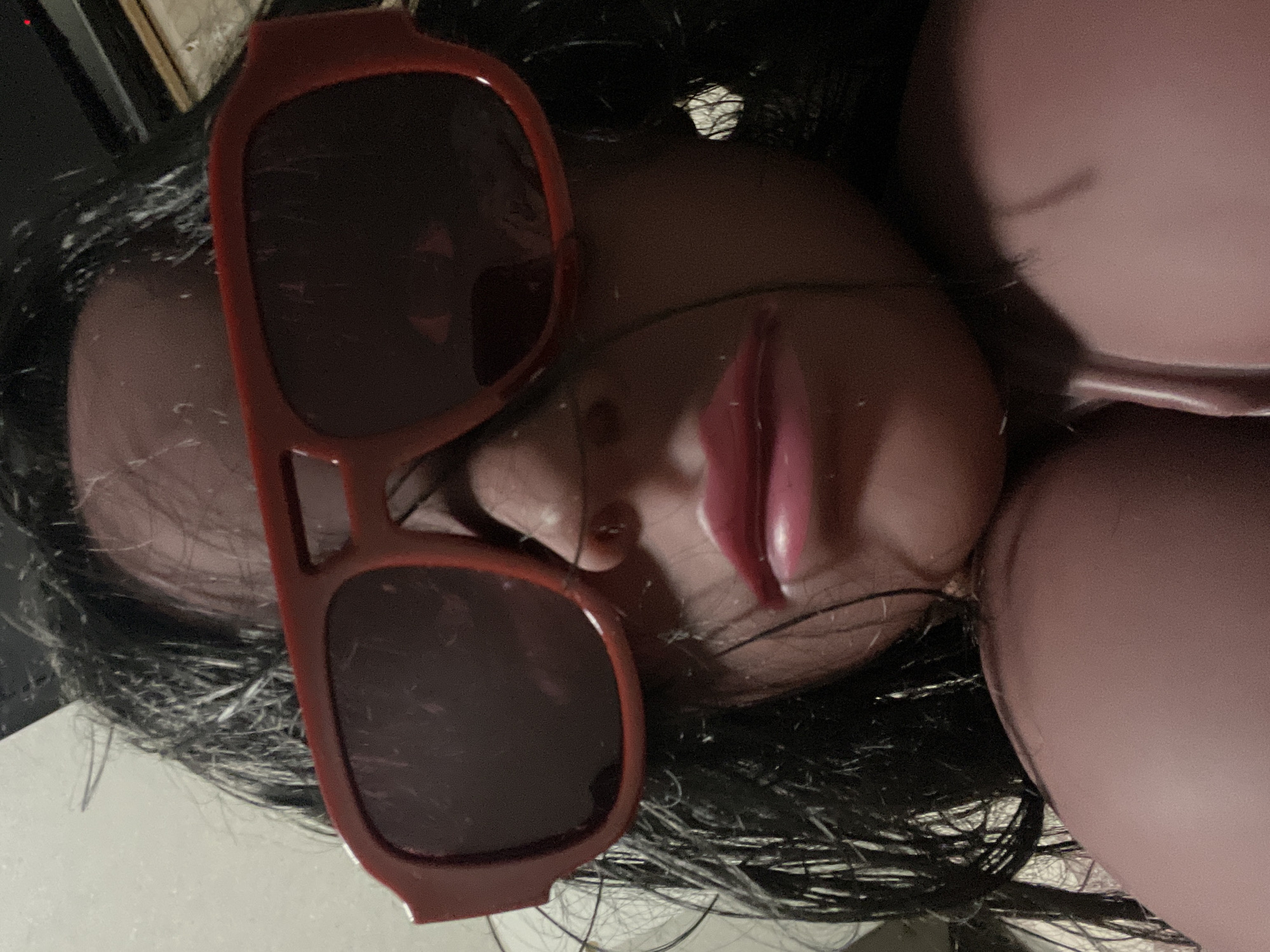 Styled mannequin heads with sunglasses in a casual still-life setup