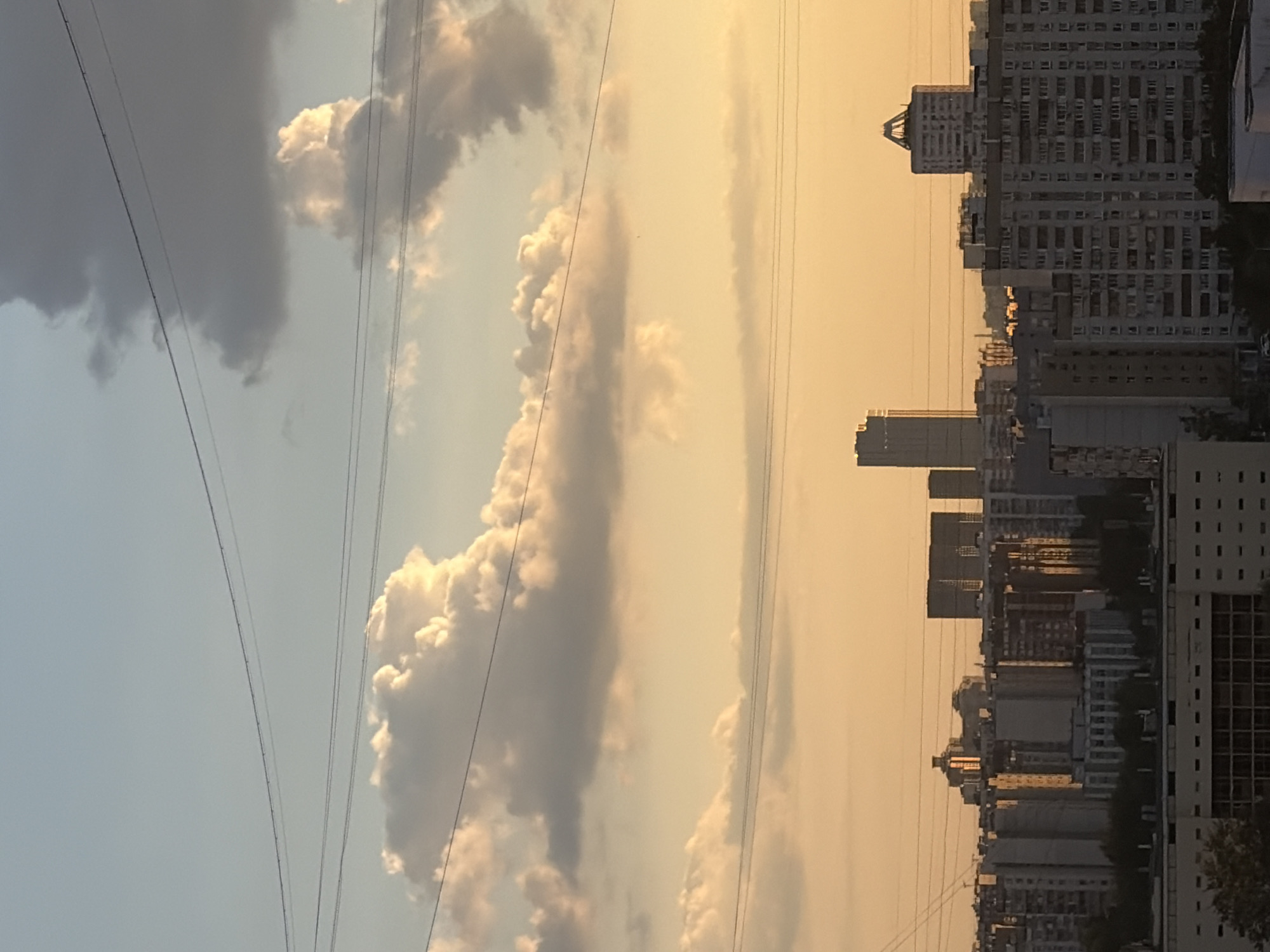 Moscow residential neighborhoods glow under a late-afternoon sunset.