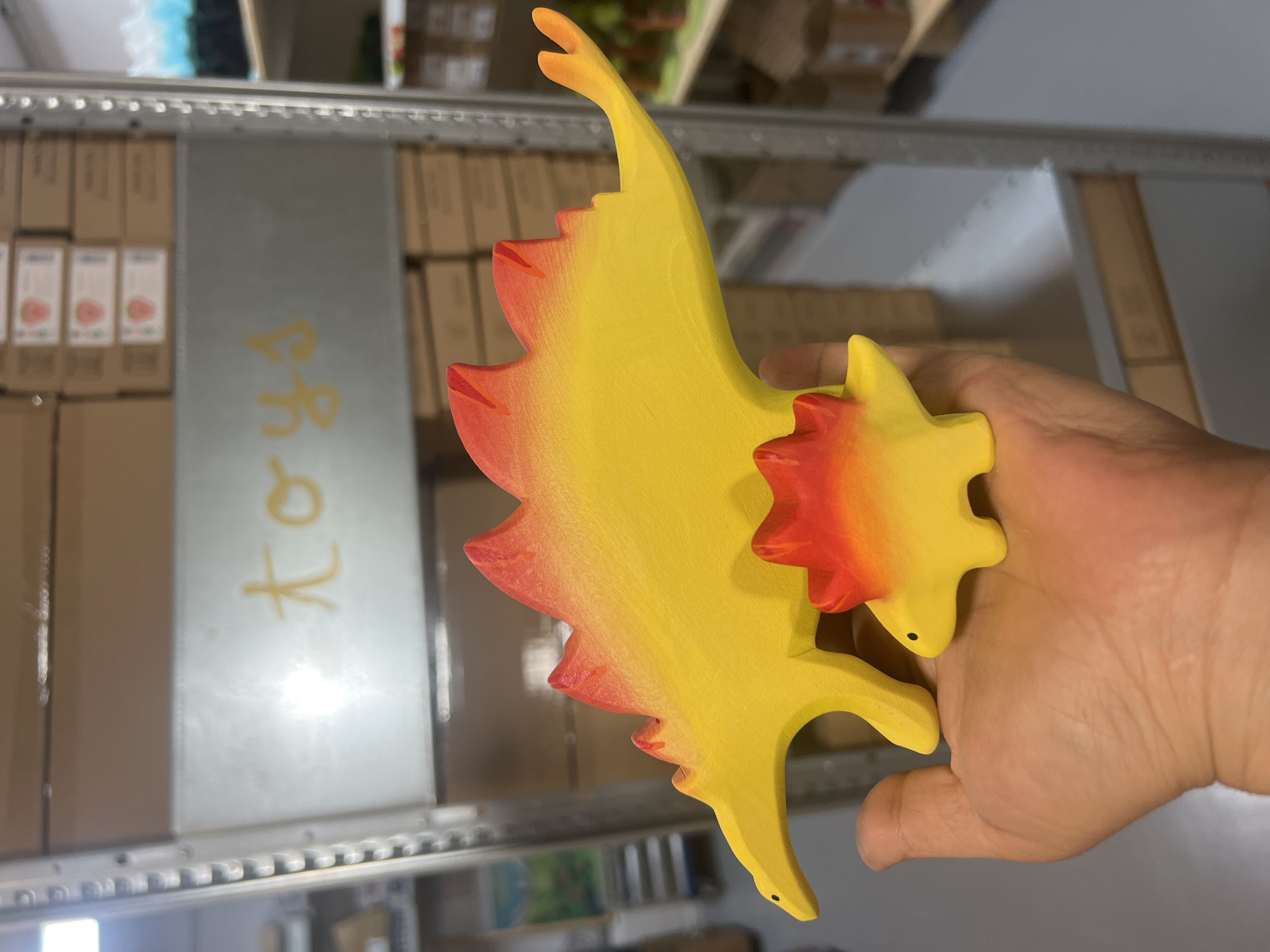 Browsing colorful handmade wooden toys and crafts in a shop