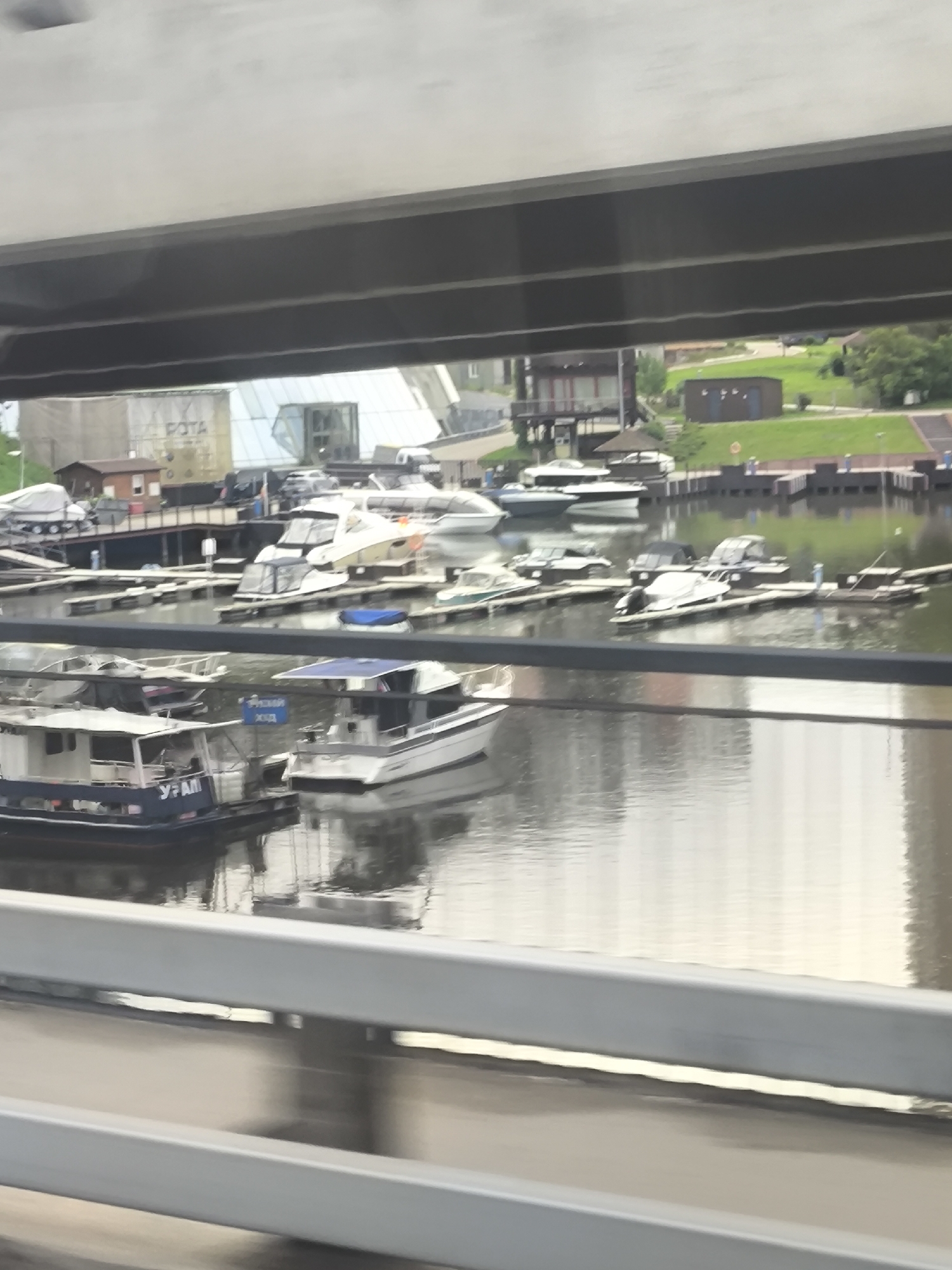 Woman photographed at waterfront marina under overcast skies