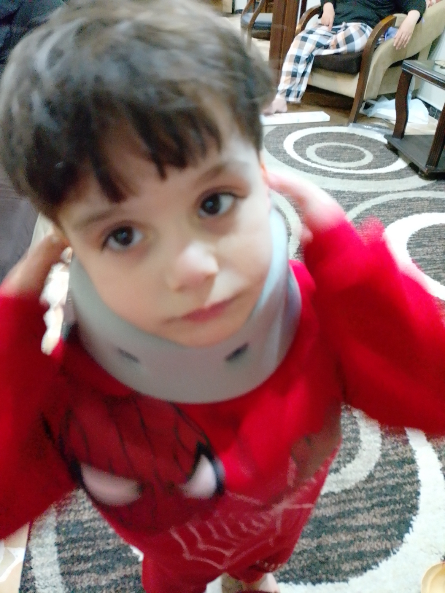Child in Spider-Man outfit enjoys fruit snacks in Syria