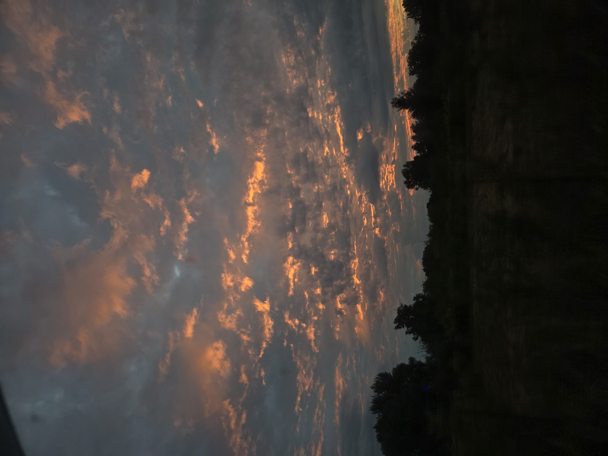 Vivid sunset sky caught from a moving car and roadside
