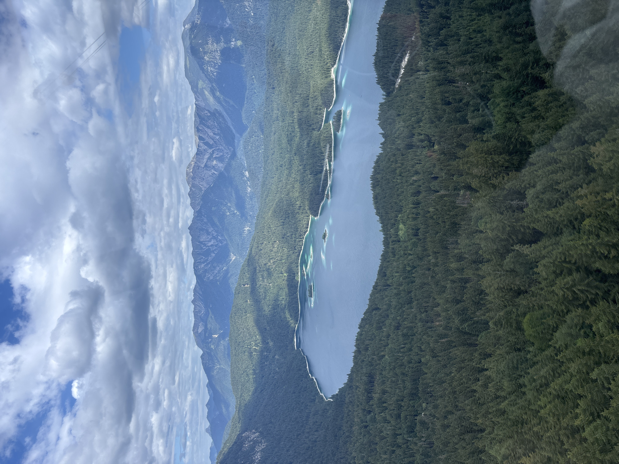 Eibsee from above, framed by forest and Alpine peaks