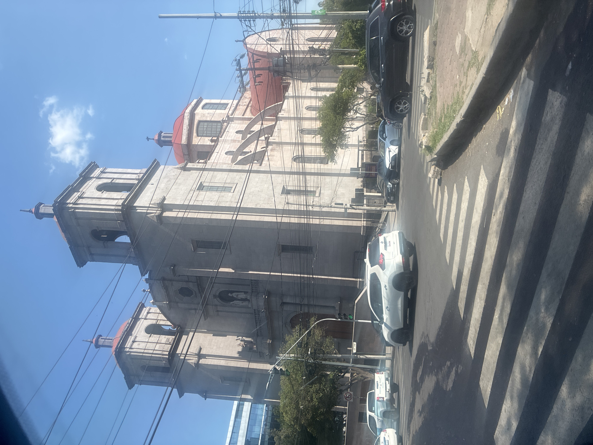 Mexico City cathedral with red domes captured in evening street scene