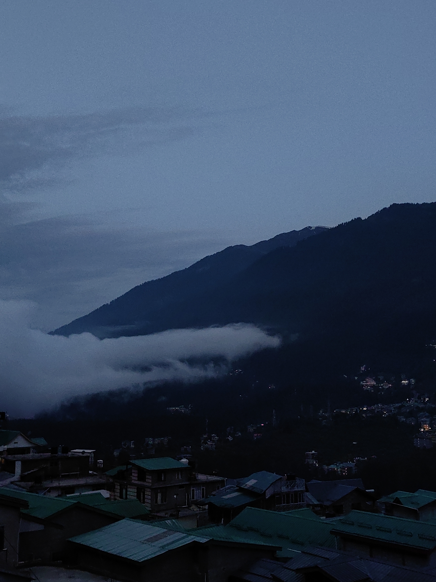 Vashisht village at dusk, Himalayan peaks in the background