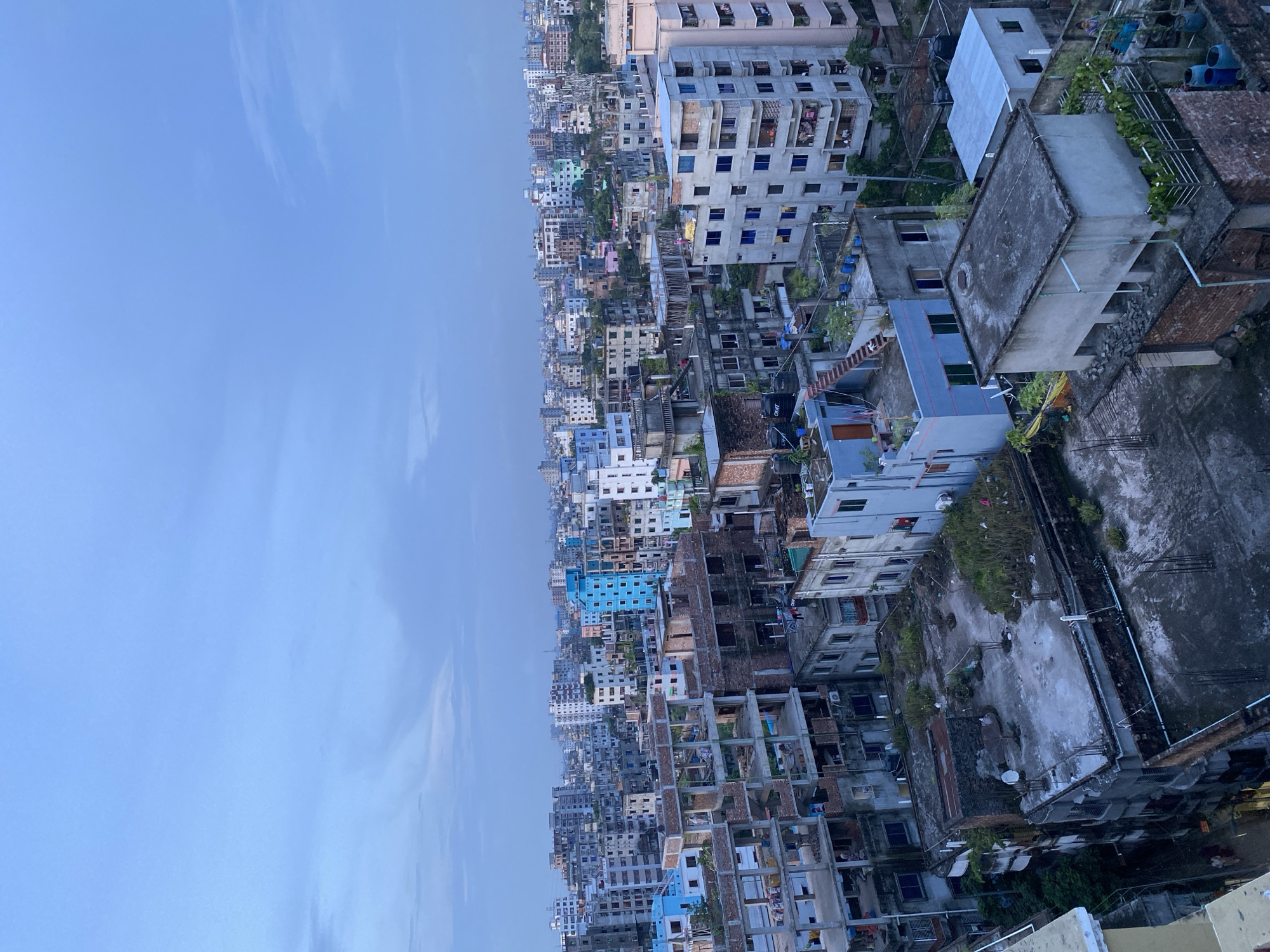 Rooftop afternoon over Dhaka's dense urban sprawl