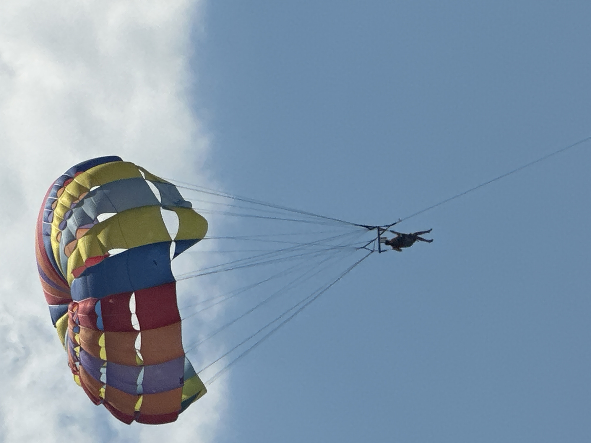 Colorful parasail rides over Boreti's coastal waters