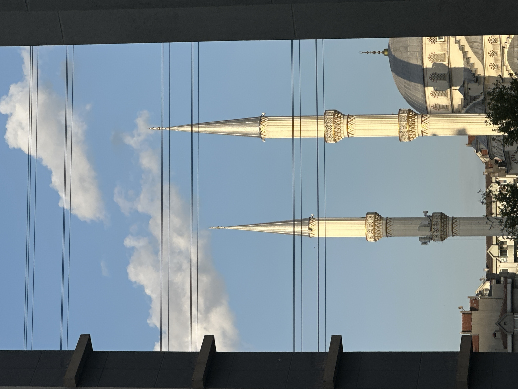 Mosque minarets framed by modern buildings in Esenyurt, Turkey