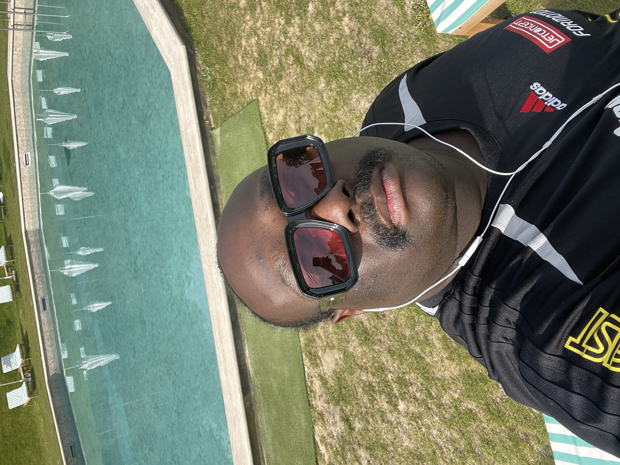 Man relaxes poolside during sunny morning in Auffargis, France