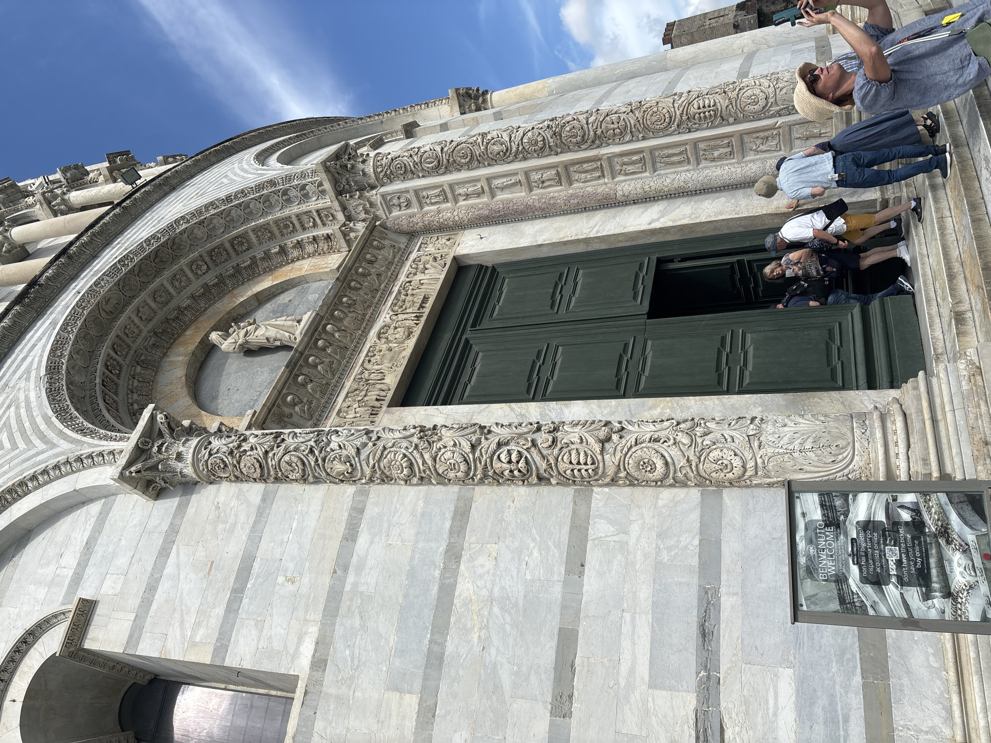 Tourist activity documented at Pisa's historic cathedral and medieval walls