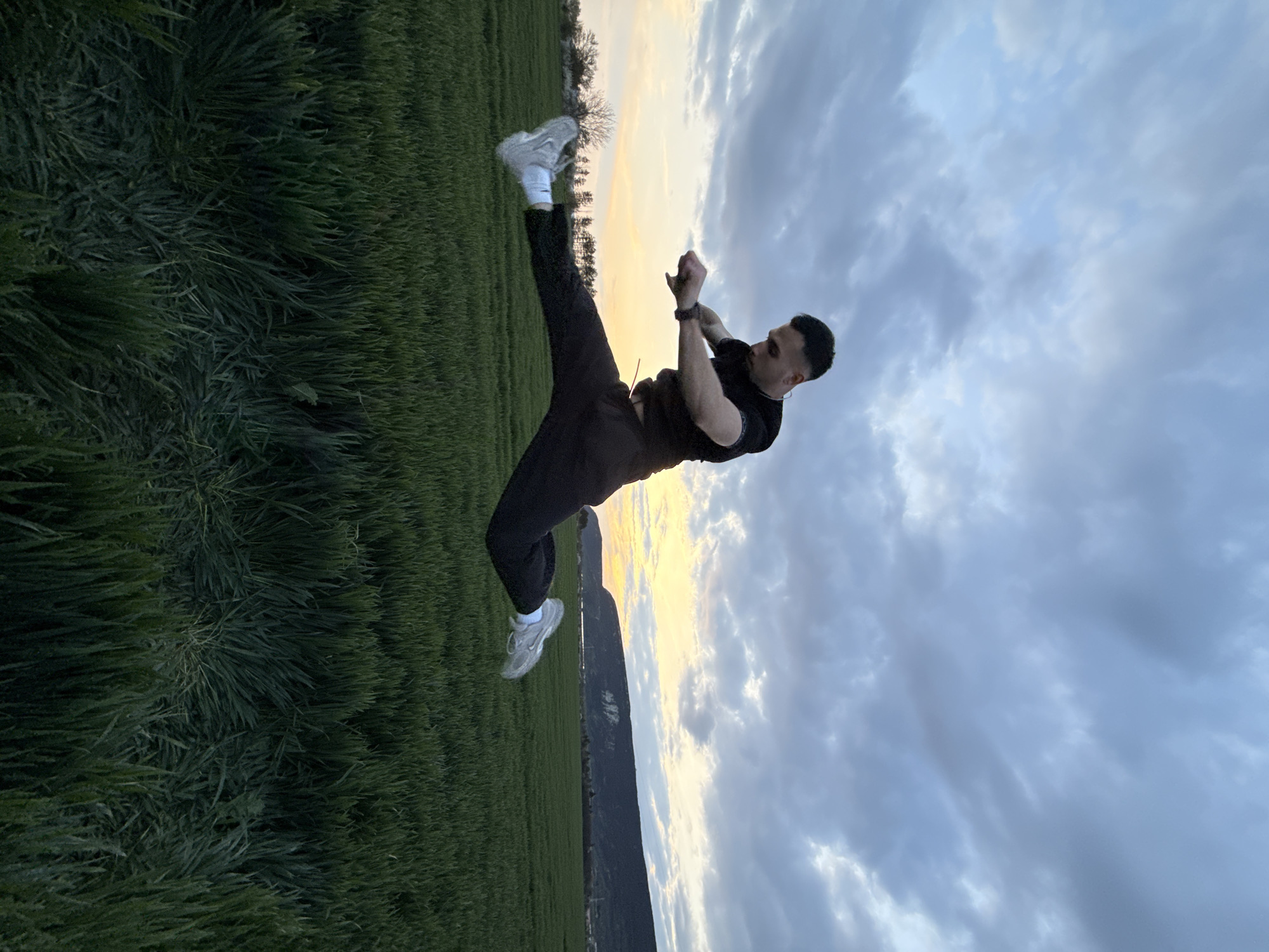 Man performs backflips in field during sunset in Bulgaria
