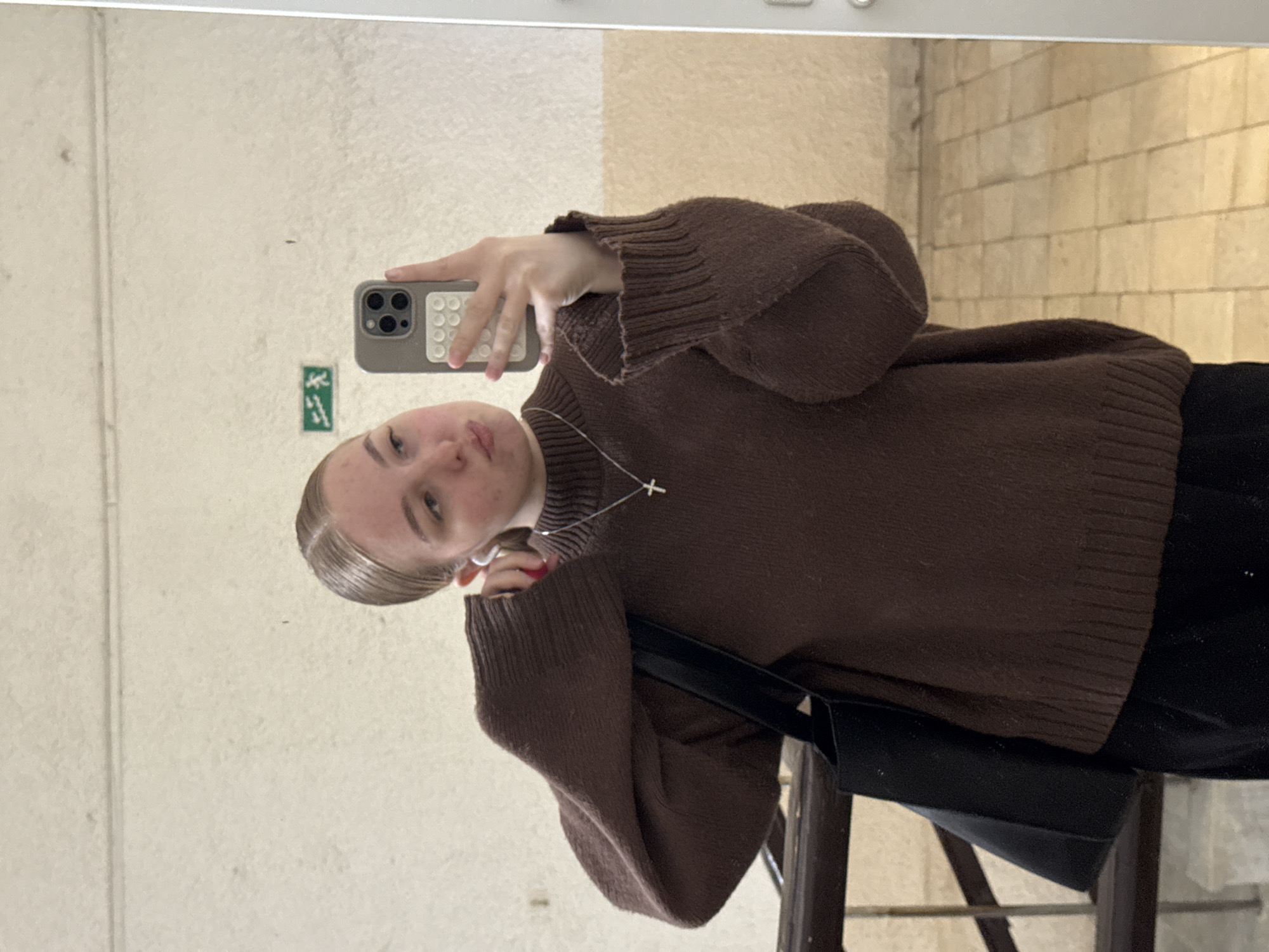 Woman takes selfie, walks hallway in Perm building