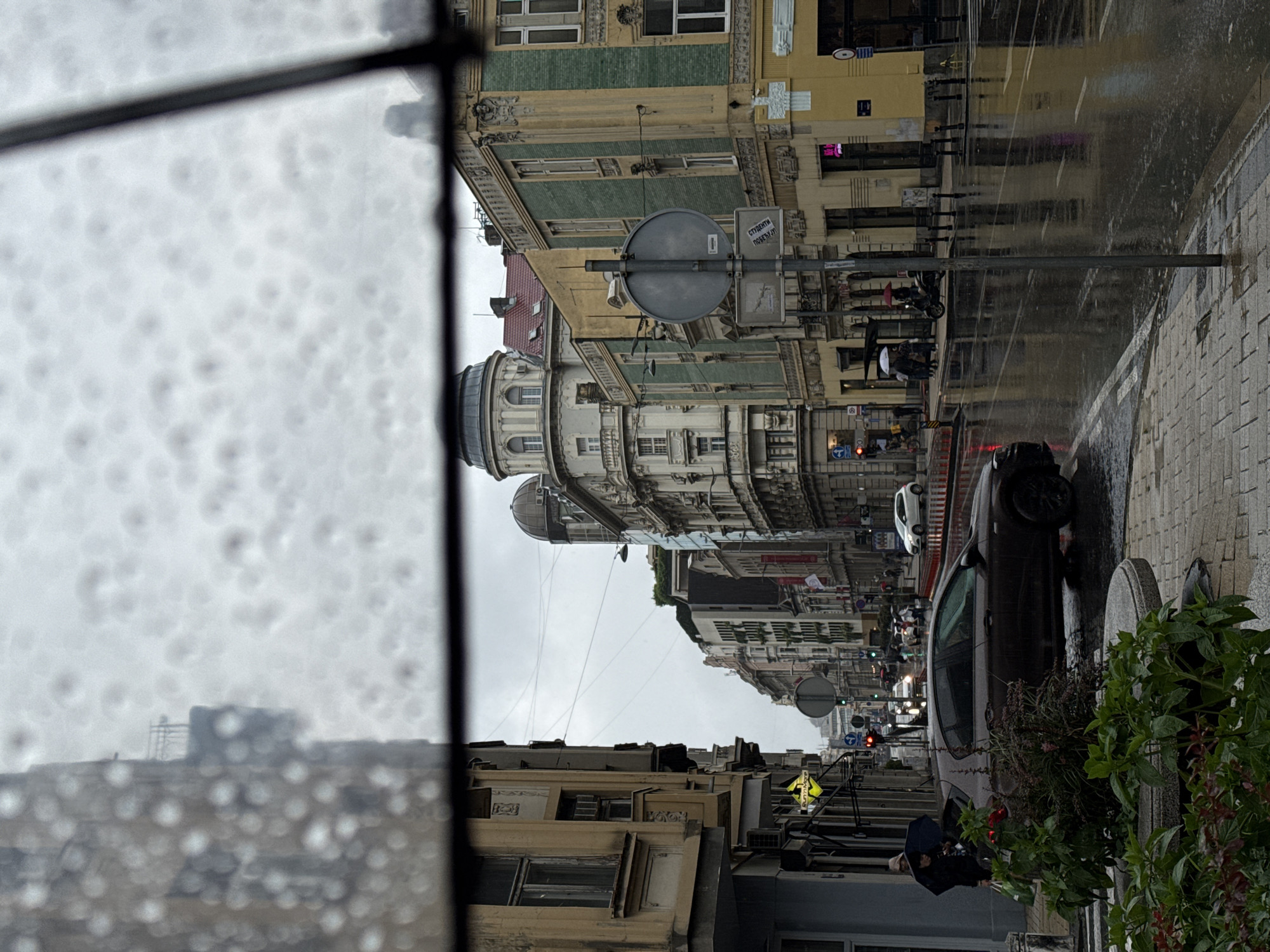 Rainy afternoon scenes documented across Belgrade streets and neighborhoods