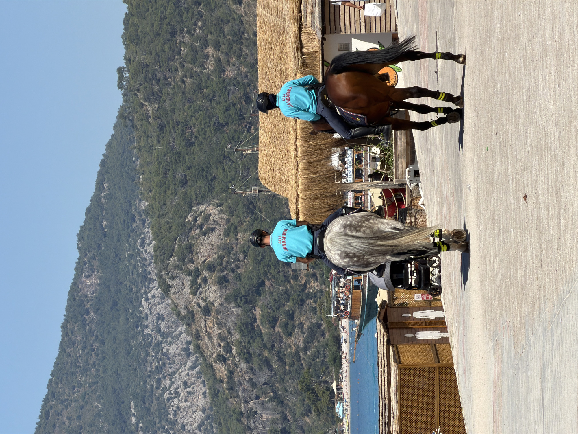 Morning beach life and mounted police patrols in Fethiye