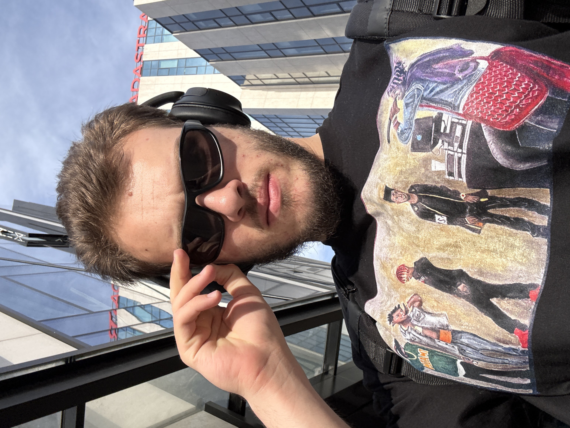 Man with sunglasses and headphones captured in close-up photograph