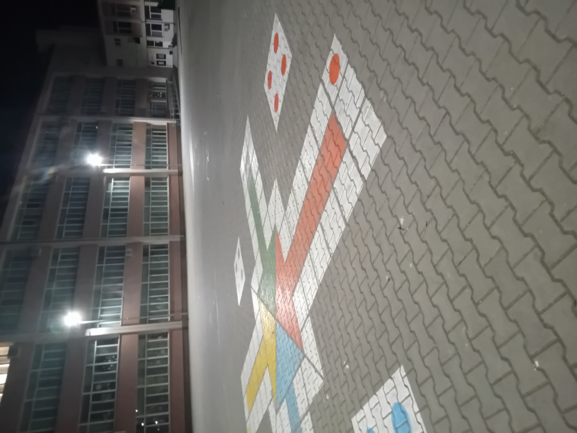 Evening documentation of community recreational area with games and artwork