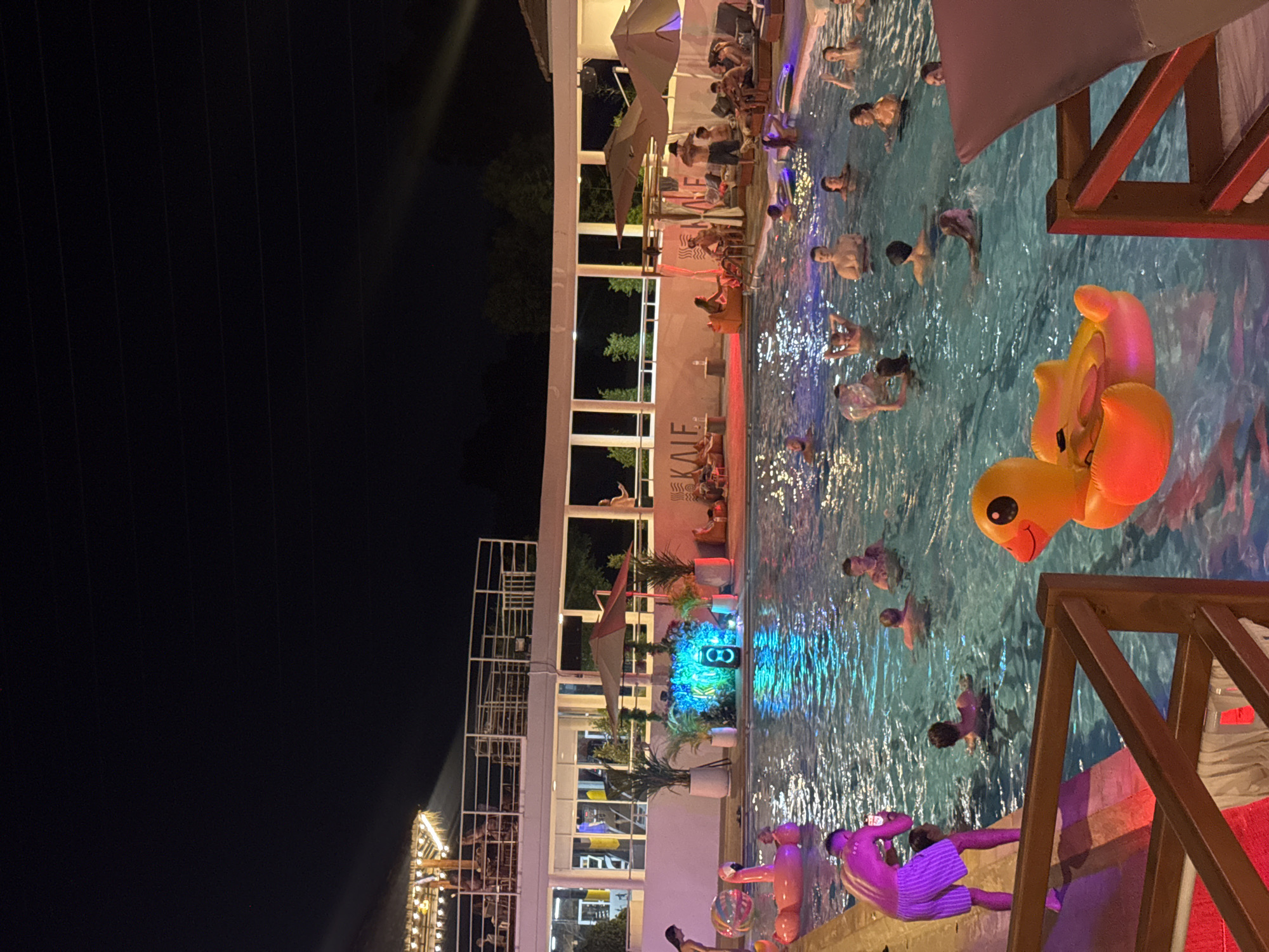 Nighttime pool gathering at Kale Pool Club in Kathu