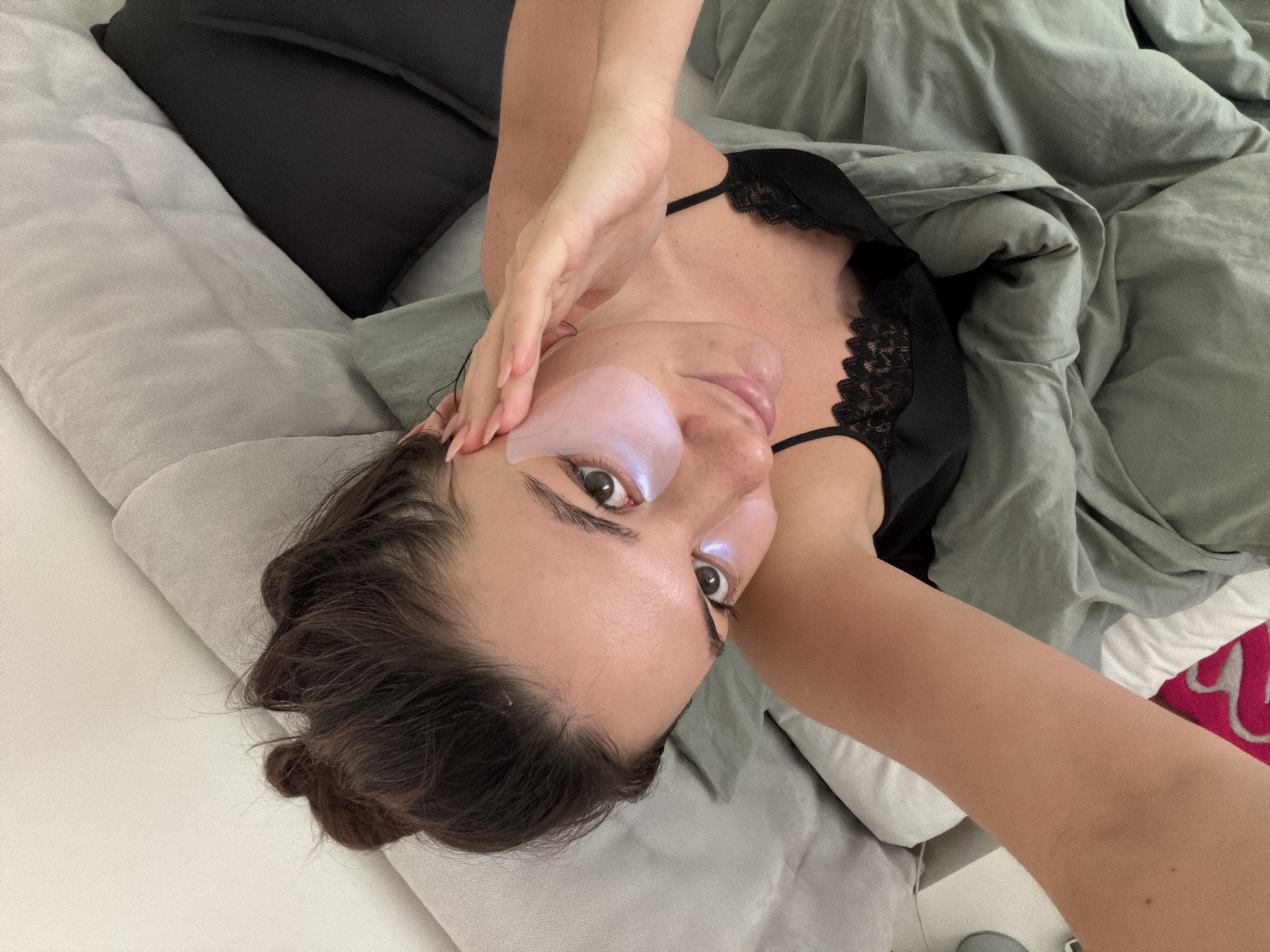 Woman rests in bed with eye mask in Belgrade