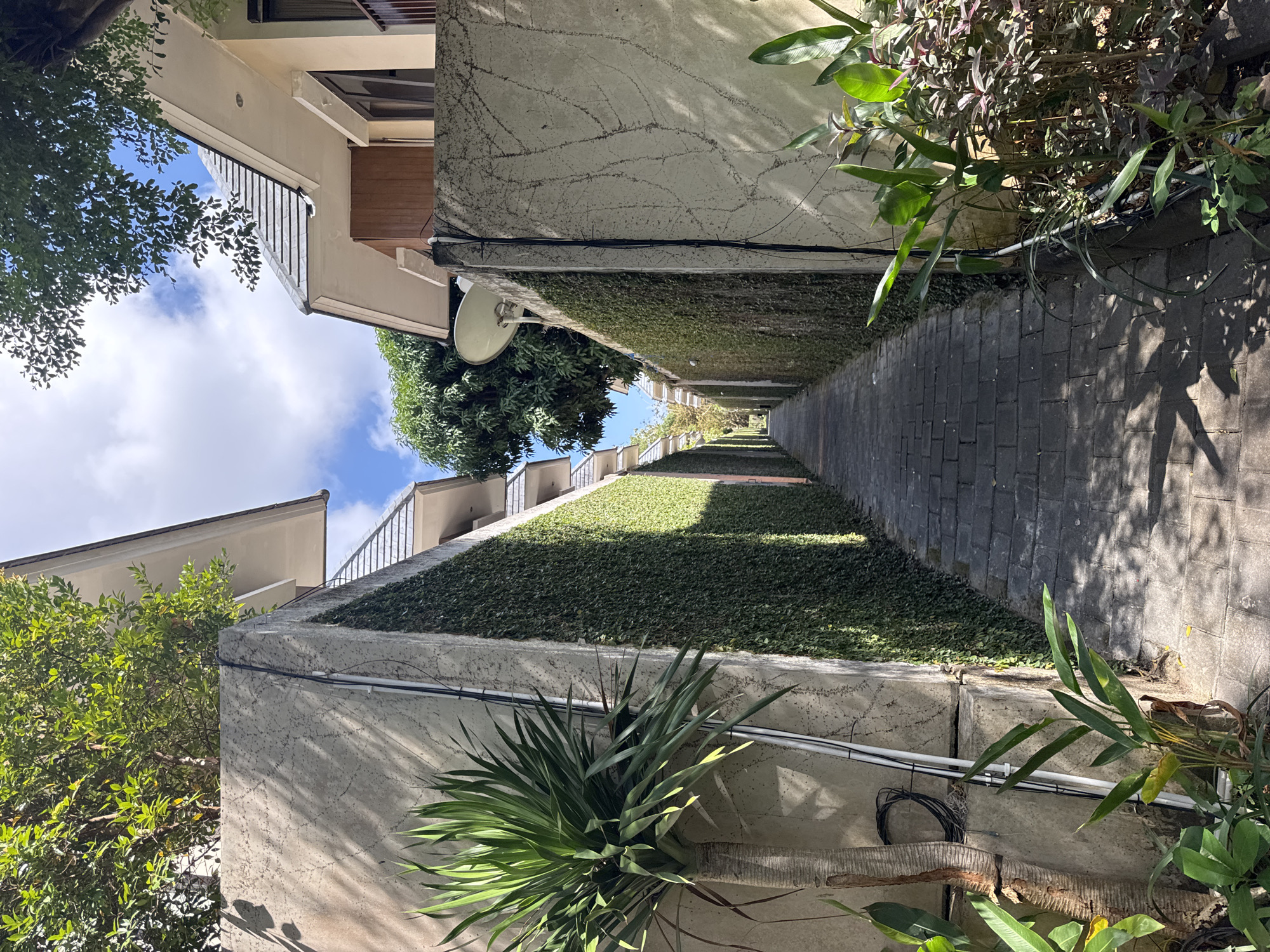 Morning grounds tour of a lush villa complex in Kuta Selatan