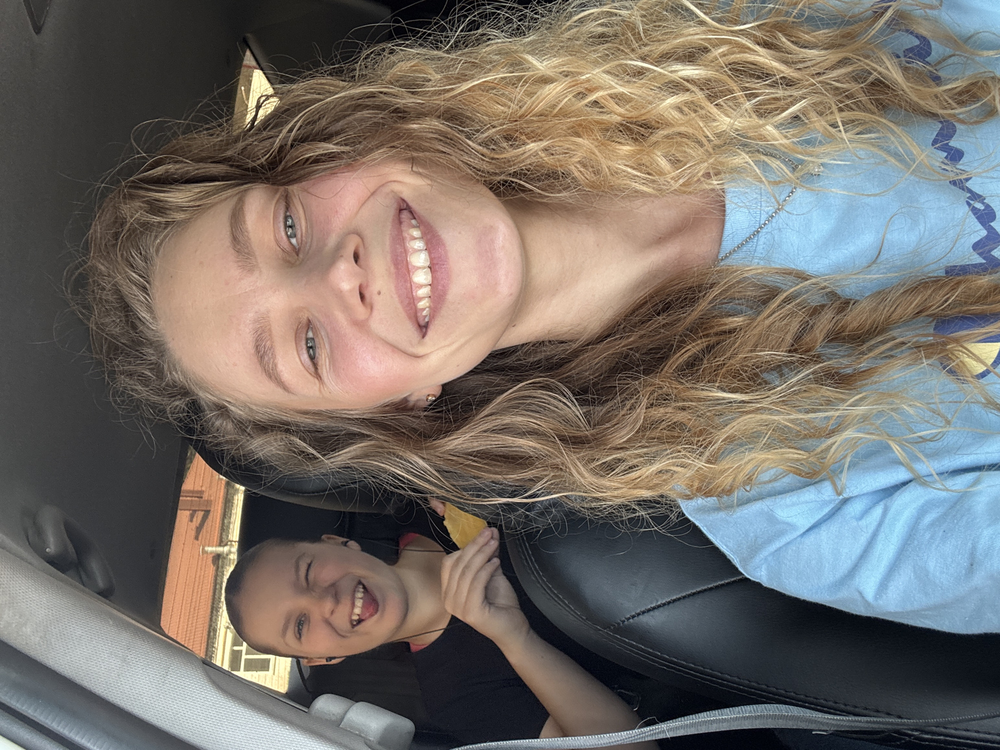 Two women smile together in car in Kurganinsk
