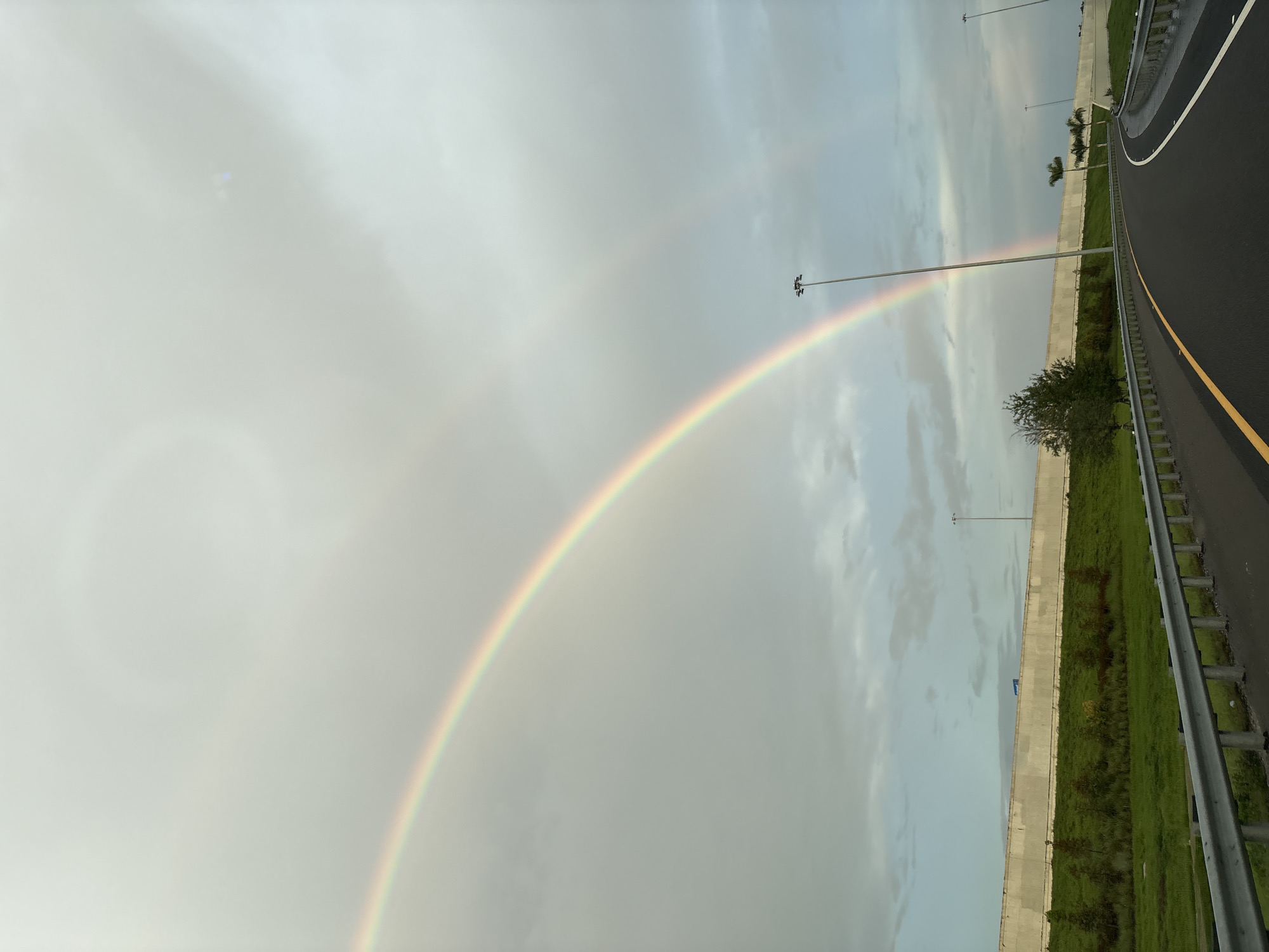Double rainbow over a Bradenton highway on a cloudy day.