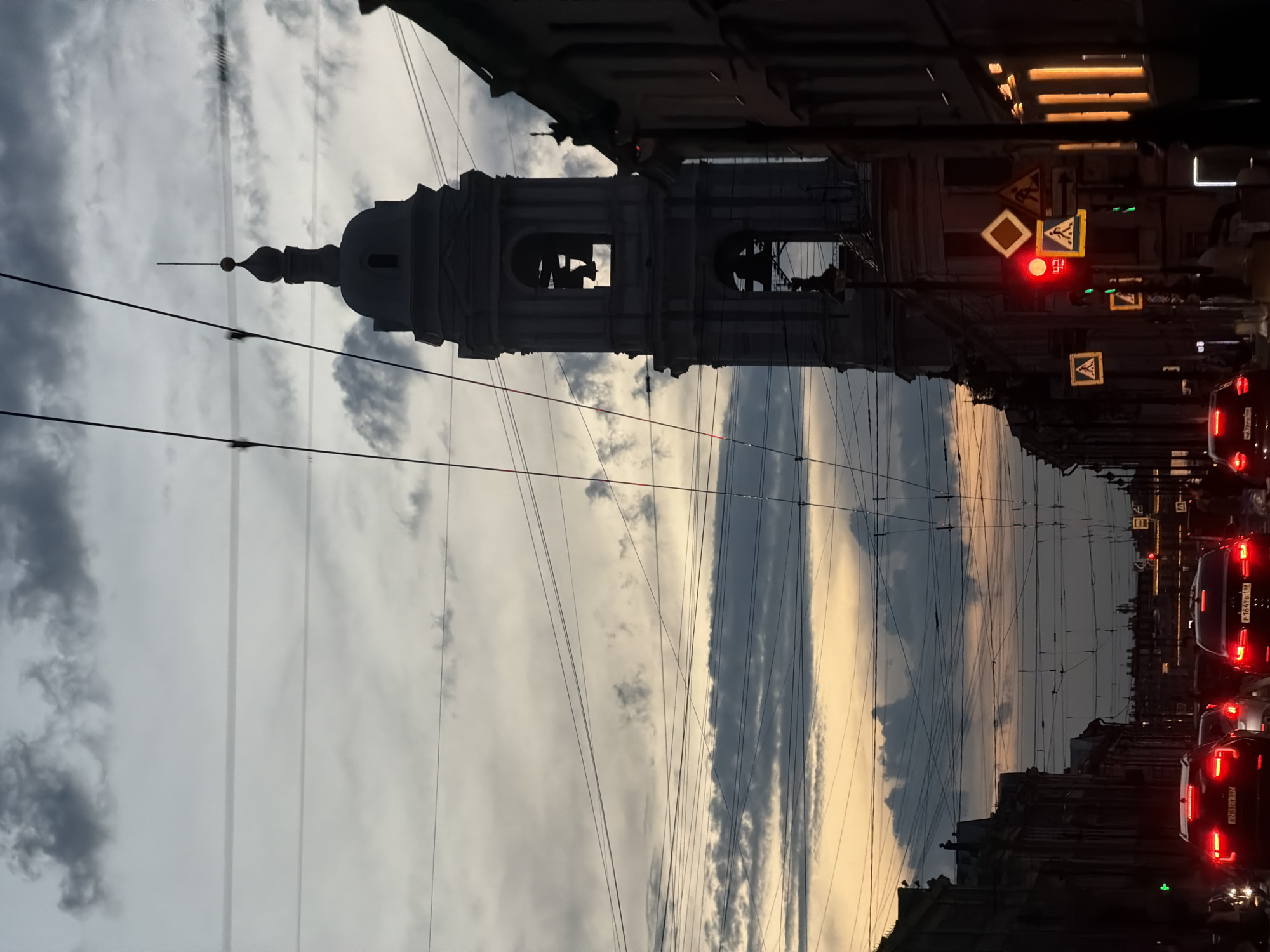 Dusk street scene photographed in Saint Petersburg showing bell tower