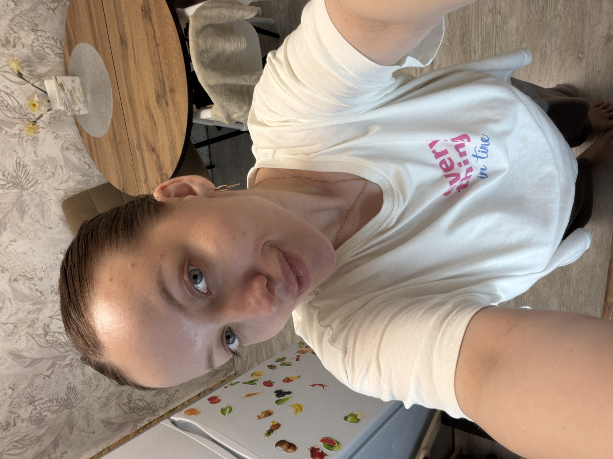 Woman takes selfie at home in Reshetnikovo kitchen