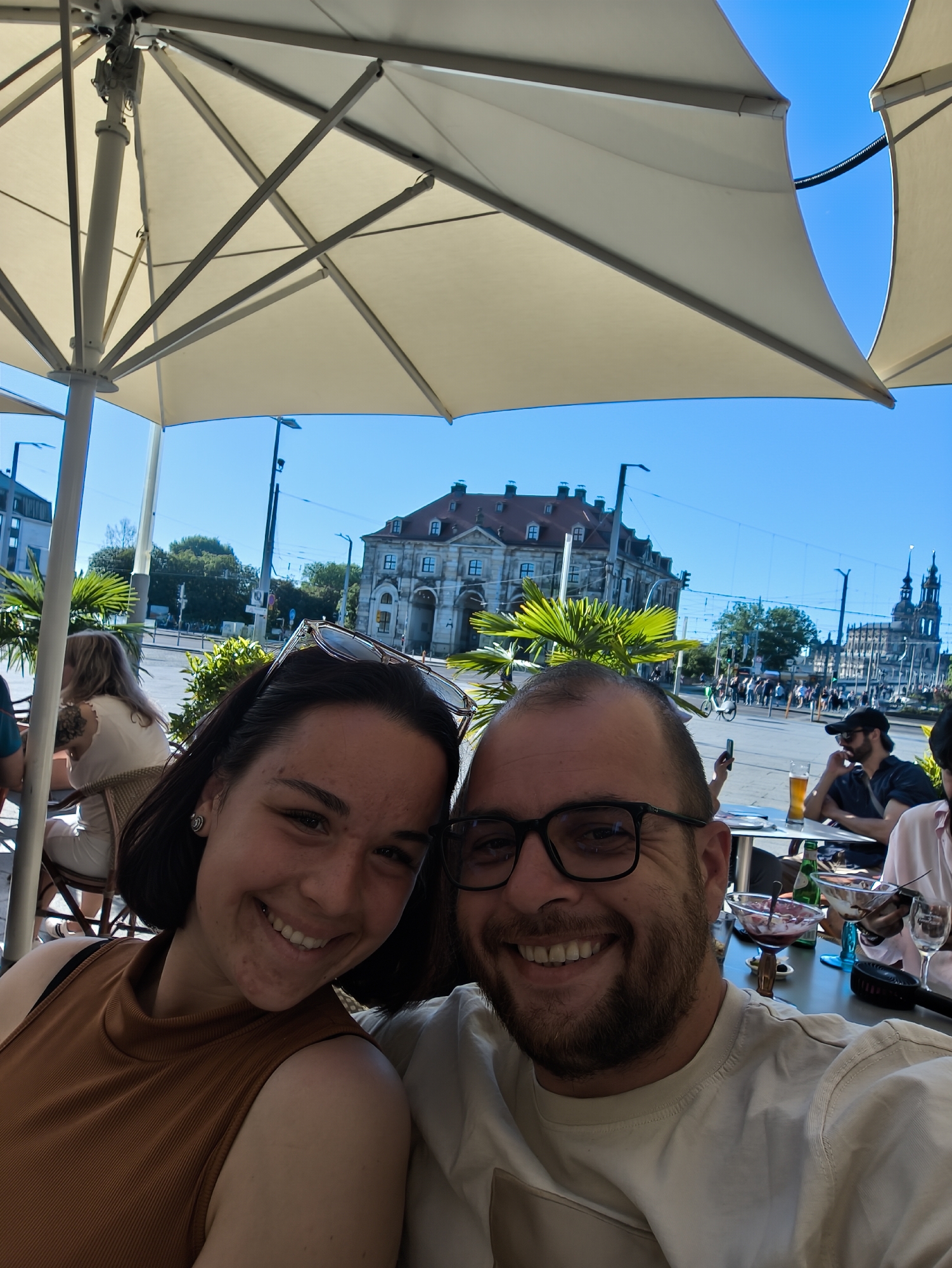 Couple dines with dog at Dresden cafe near Frauenkirche