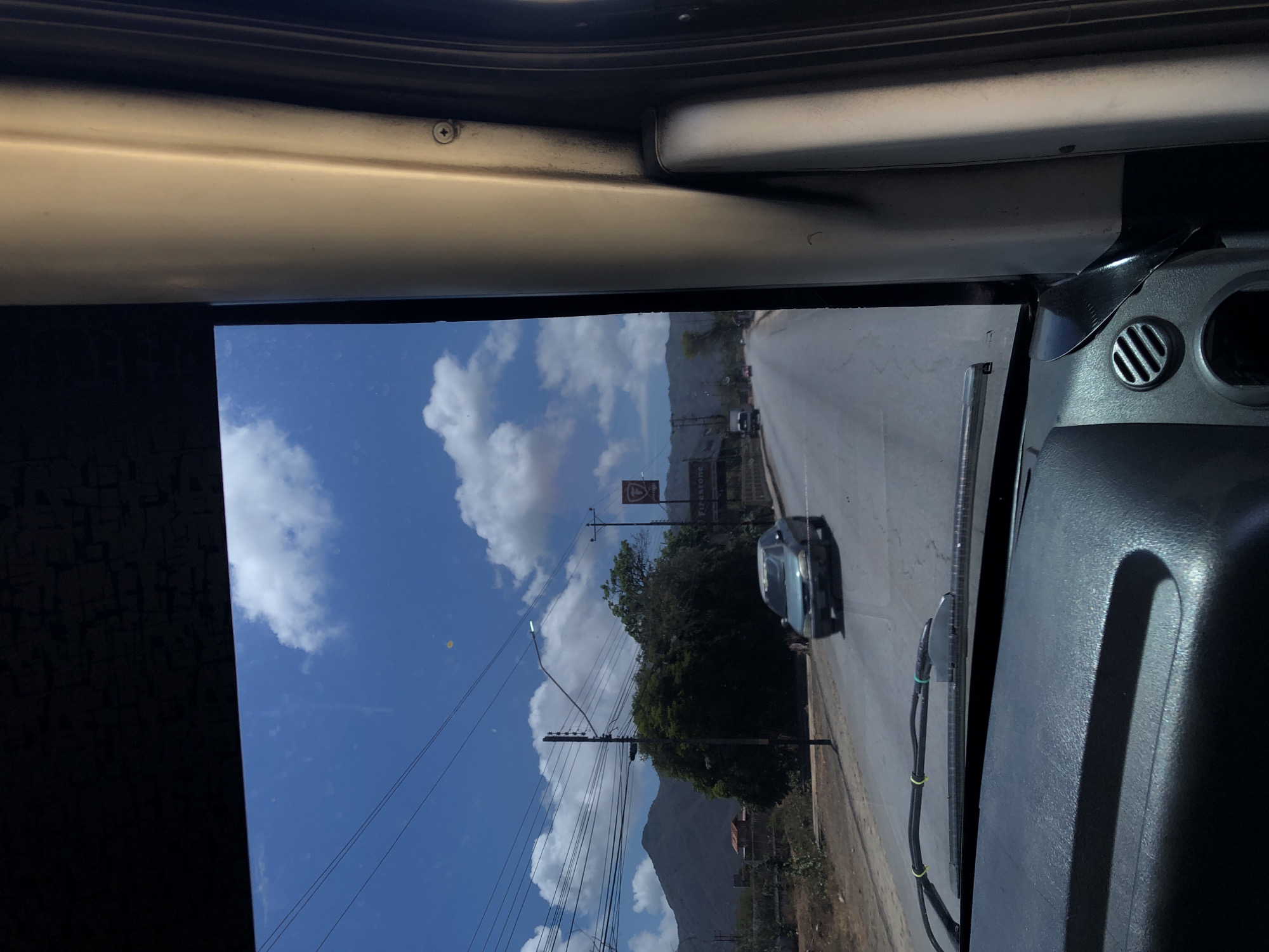 Vehicle journey documented through windshield in Venezuelan countryside
