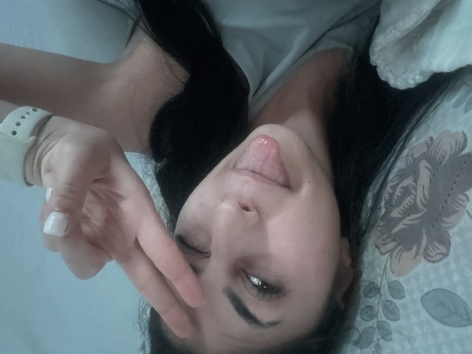 Person makes playful gestures on bed in Bulgaria