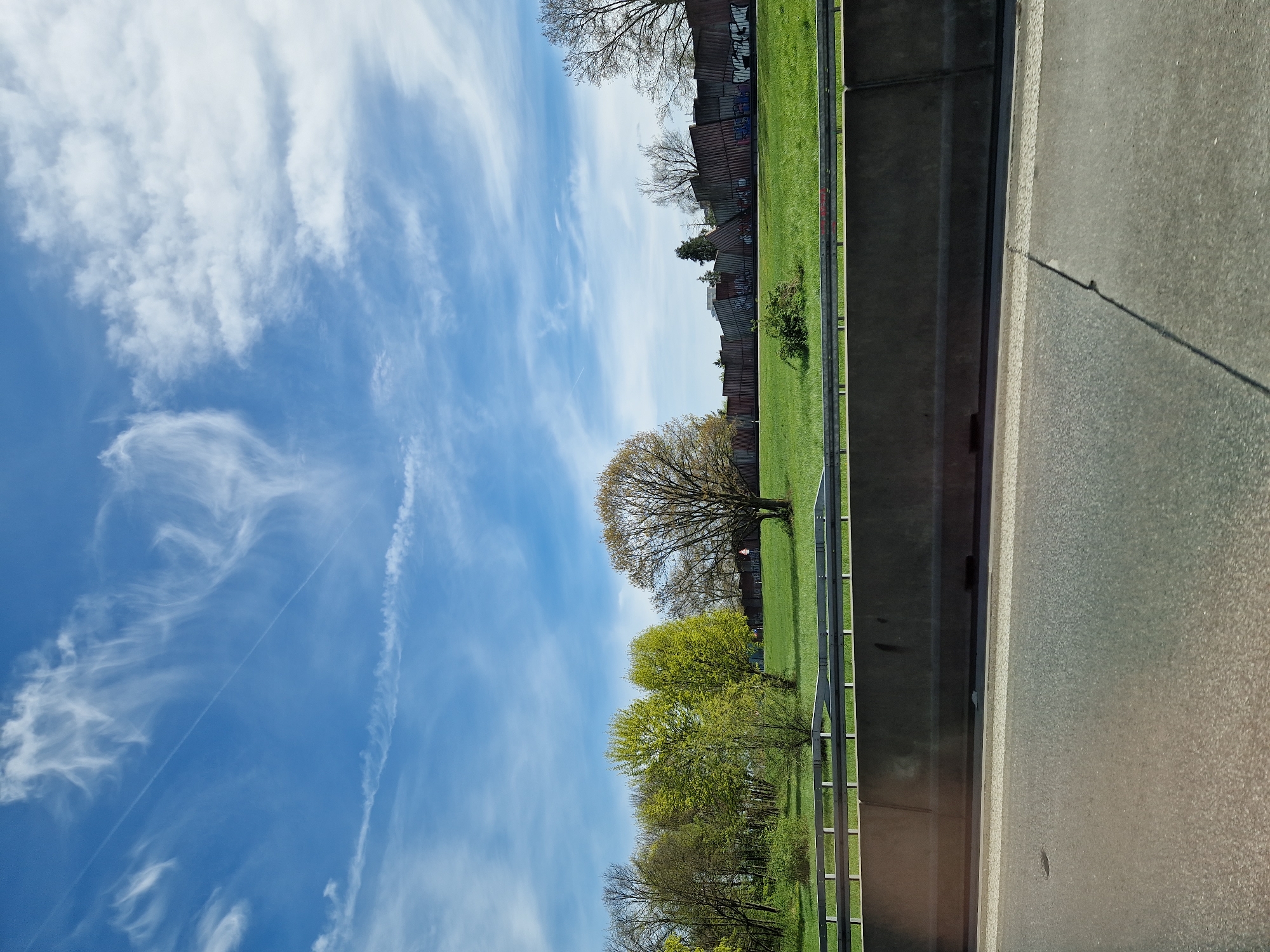 Vehicle travels Karlsruhe highway under blue skies with clouds