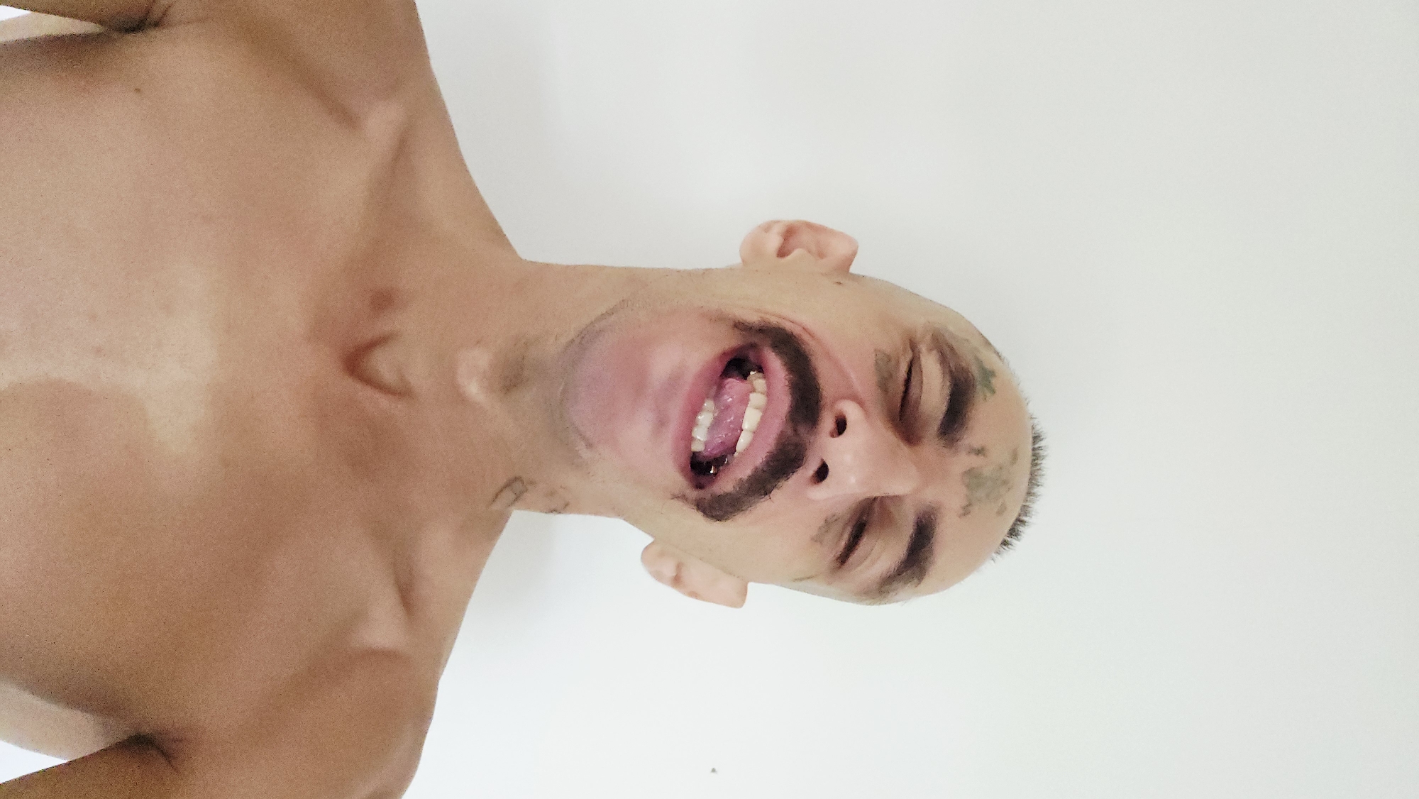 Tattooed man photographed in portrait session in Cam Lâm