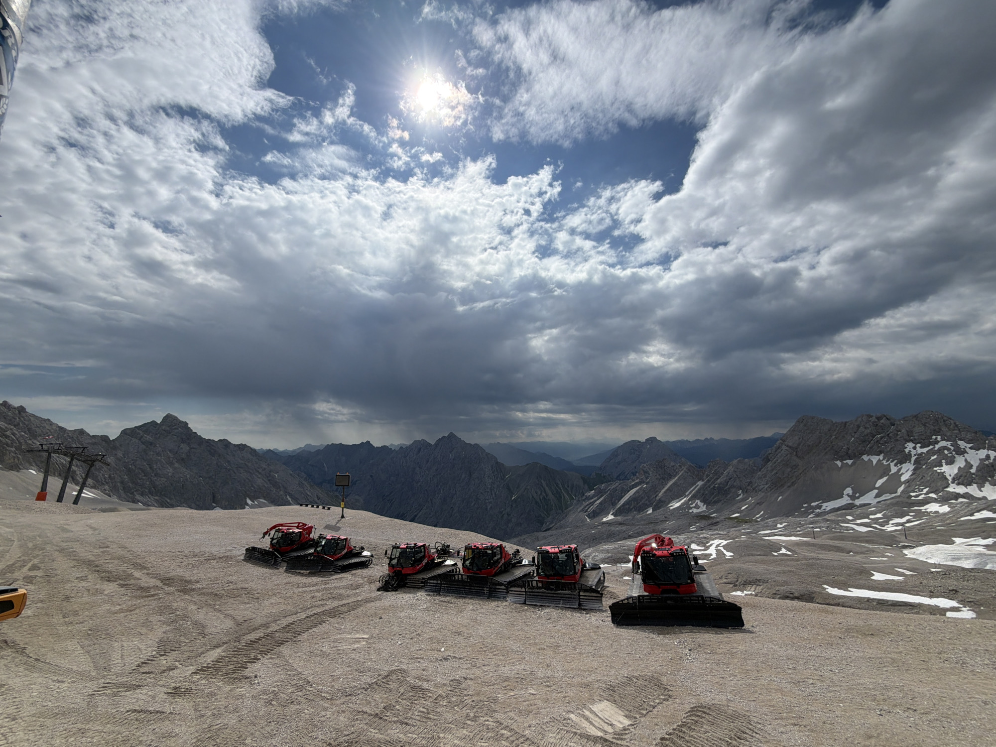 Summer morning at the Zugspitze: snow groomers, rocky terrain, and alpine views