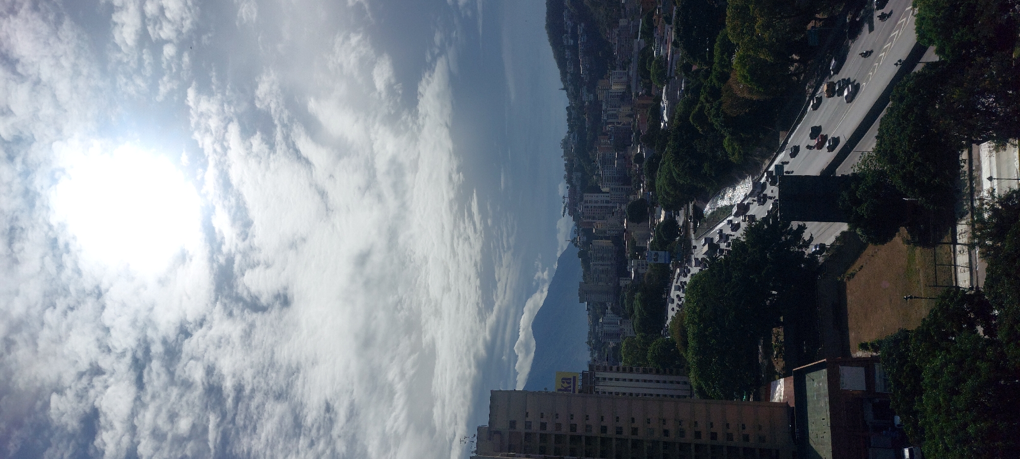 Daylight panoramic views captured of Caracas cityscape under bright skies
